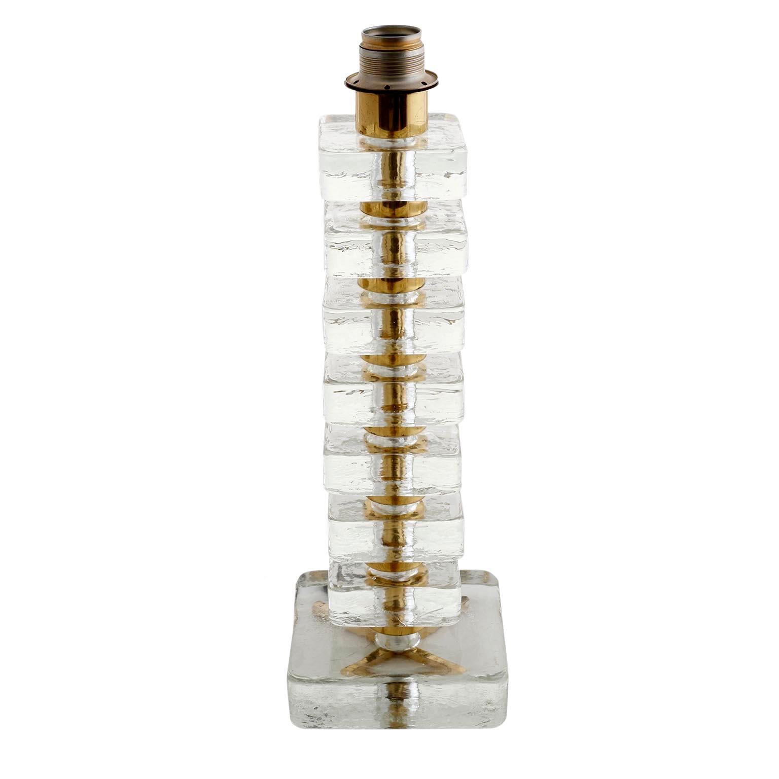 A pair of large and high quality Mid-Century Modern table lights by Bakalowits & Söhne, Vienna, manufactured circa 1970 (late 1960s or early 1970s). The stand is made of thick and square pieces of glass stacked with brass spaces. 
The neutral cream