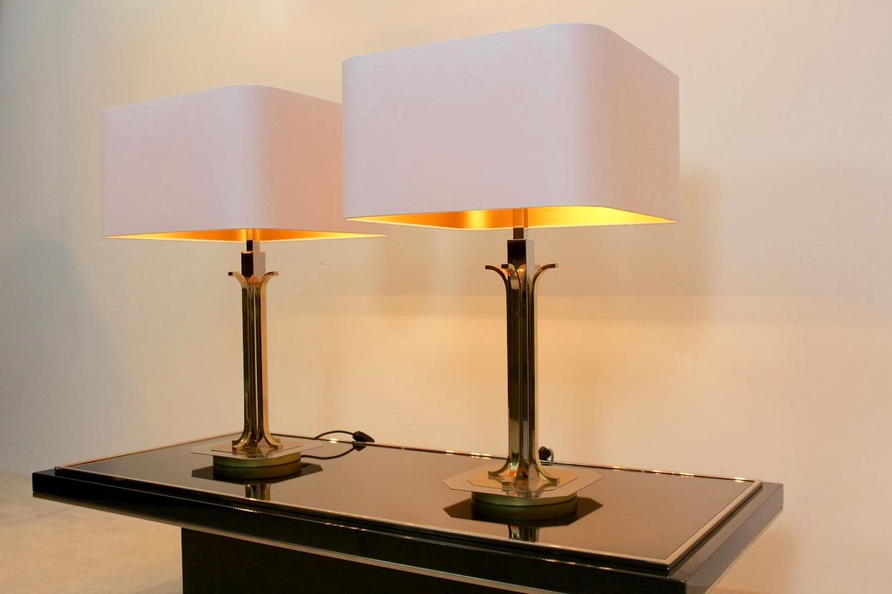Beautiful pair of large brass and chrome midcentury table lamps from the 1970s in Willy Rizzo style. The set is unique and has a glamorous appearance and has 4 lights per lamp. The beautiful white shades are new and give a very sophisticated and