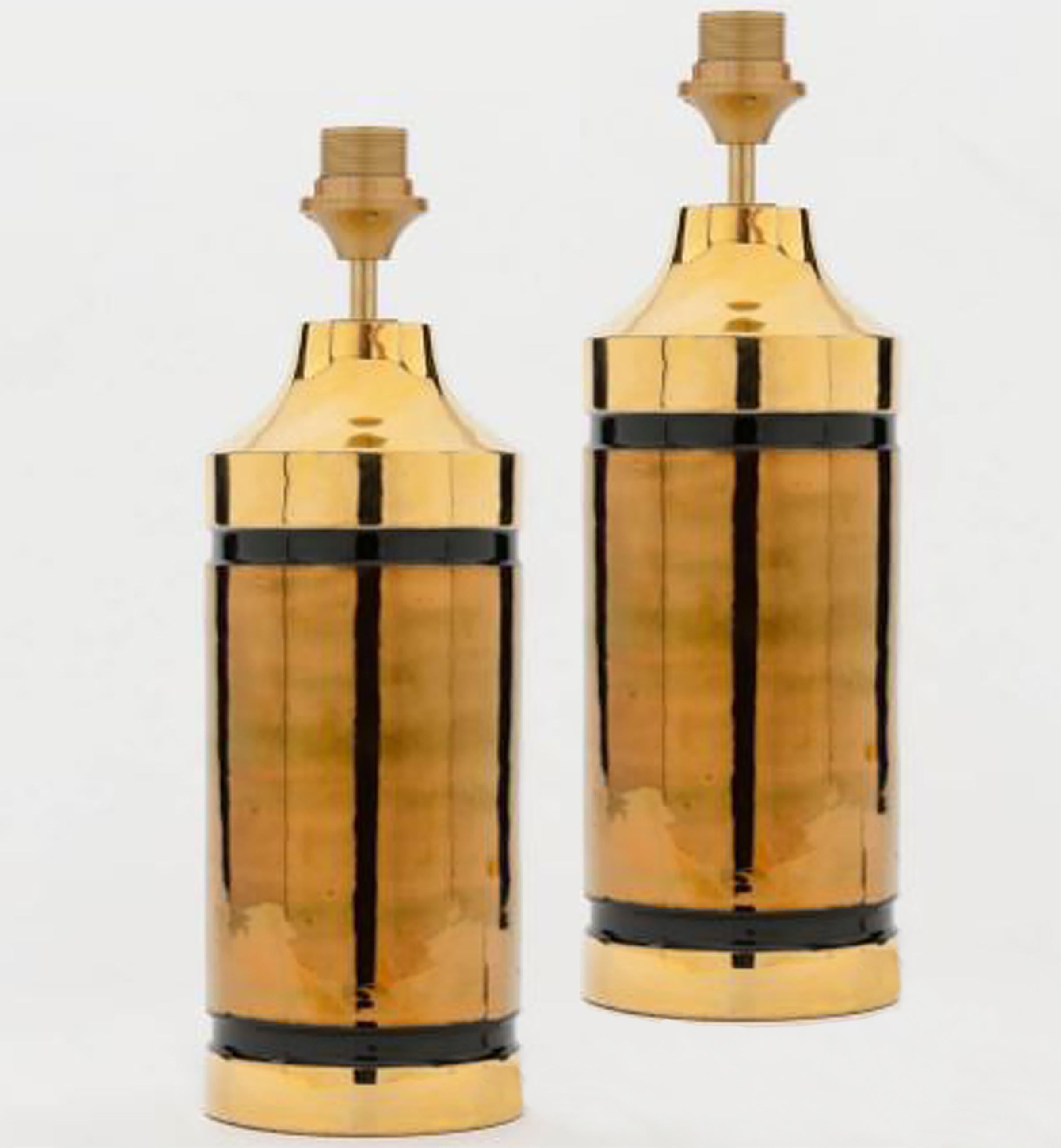 Pair of large table lamps. Each lamp features a ceramic base with a rough surface in a brown glaze at the top and bottom and a gold bowl in the middle. Bitossi for Bergboms, Italy, circa 1960s. With exceptional new custom made shades by René Houben.