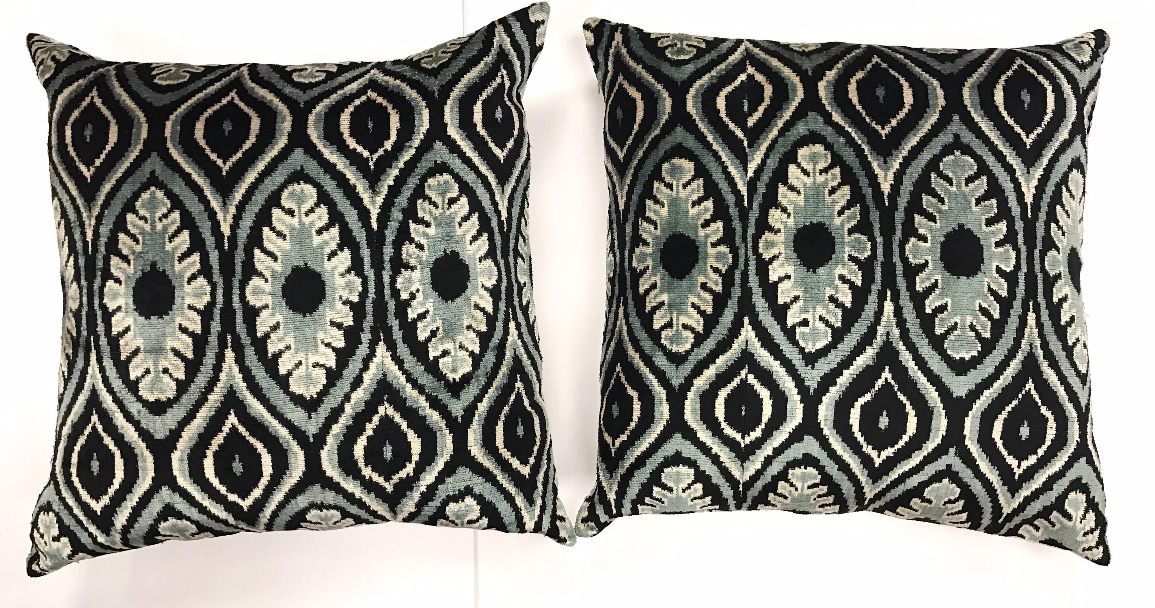 With their brilliant colors and bold design, Ikats are some of the most distinct and sought after fabrics produced in the world. This pair of handmade silk Ikat pillows are down filled and both tied and dyed by hand. This makes each Ikat design one