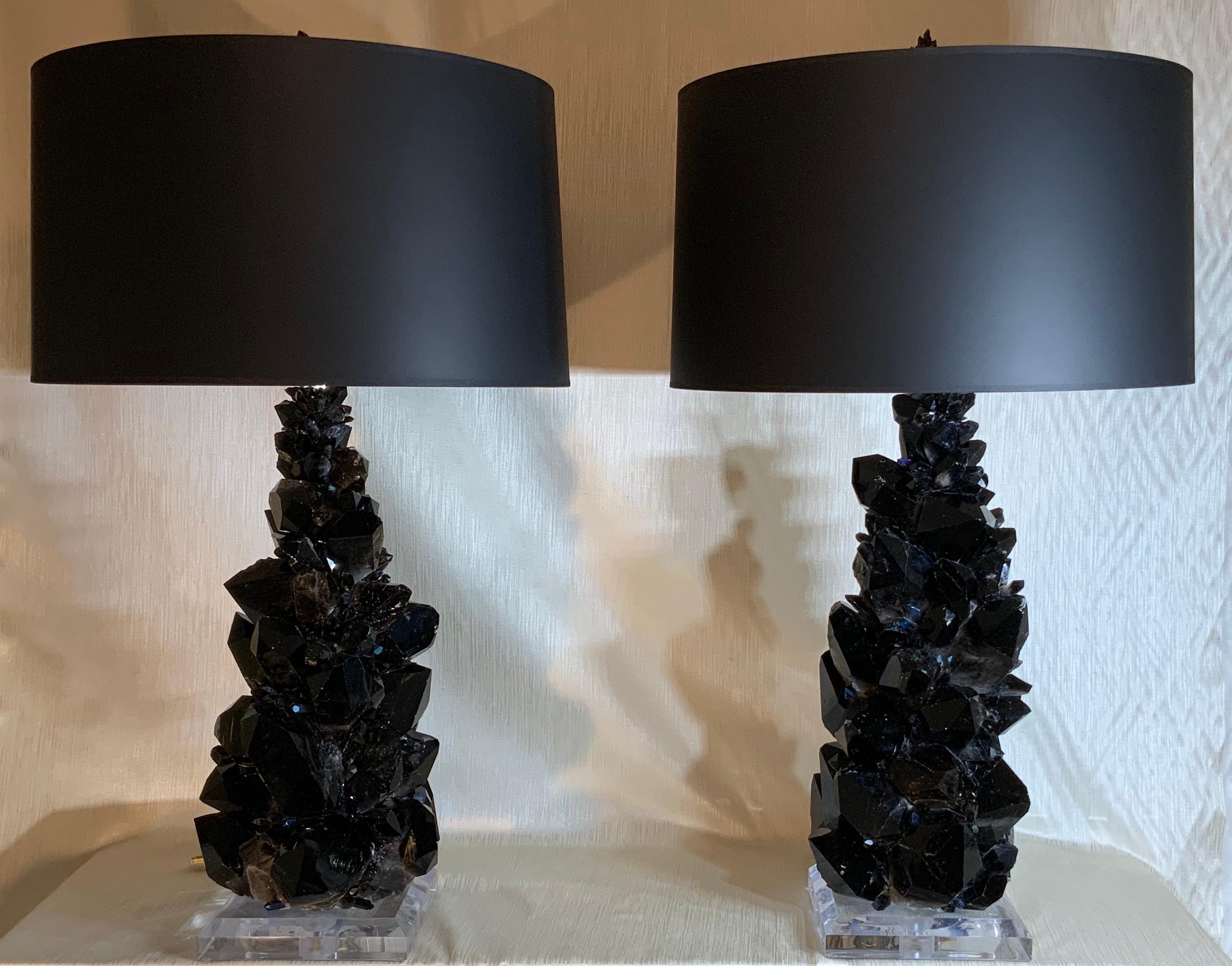 Exceptional pair of table lamps made of large and smaller genuine black and smoky color rock quartz crystal pieces, artistically put together to make beautiful and impressive pair of table lamps.
Beveled Lucite base 8” x 8” x 1.5
Height of the lamp