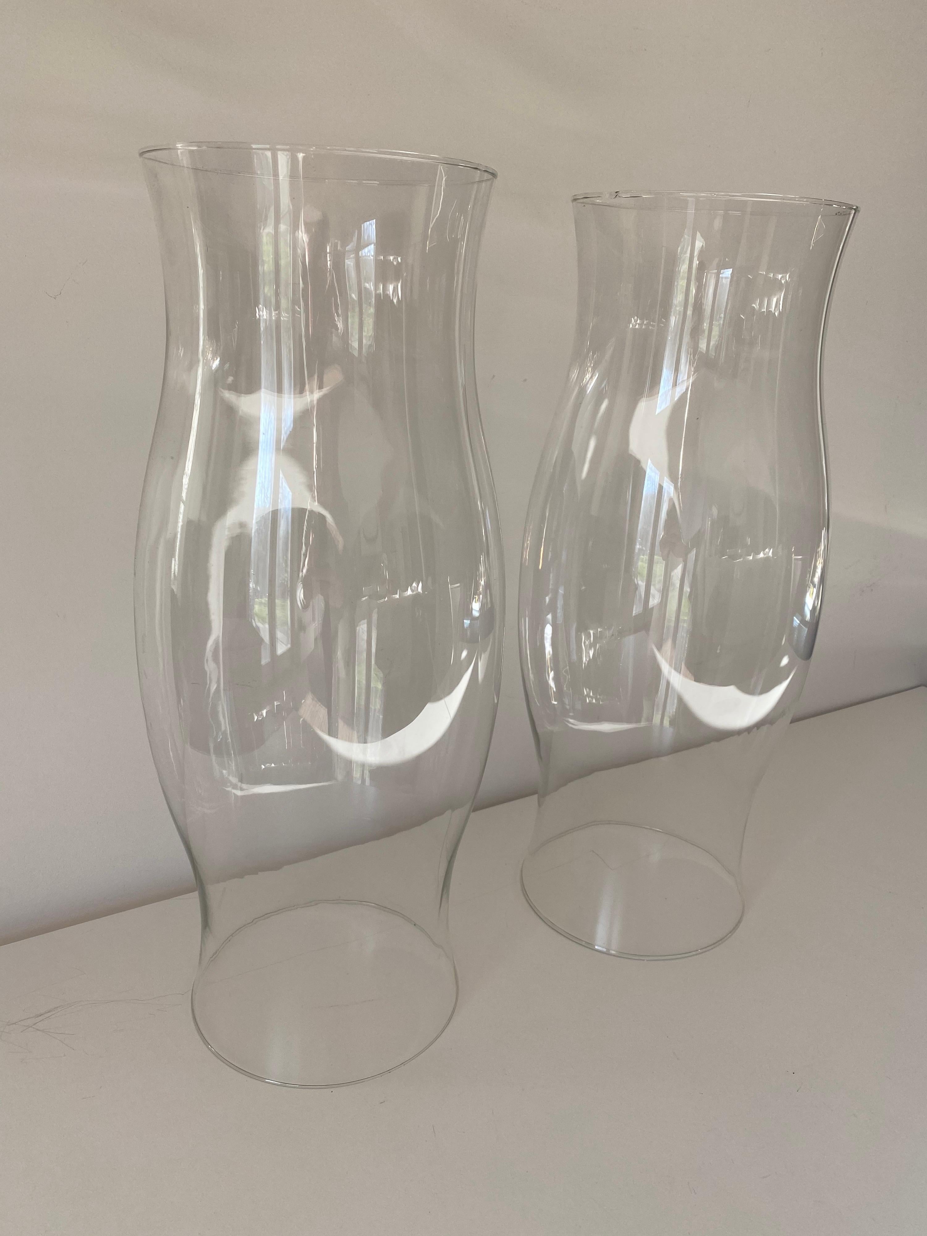 A pair of large early 20th century blown glass hurricanes.