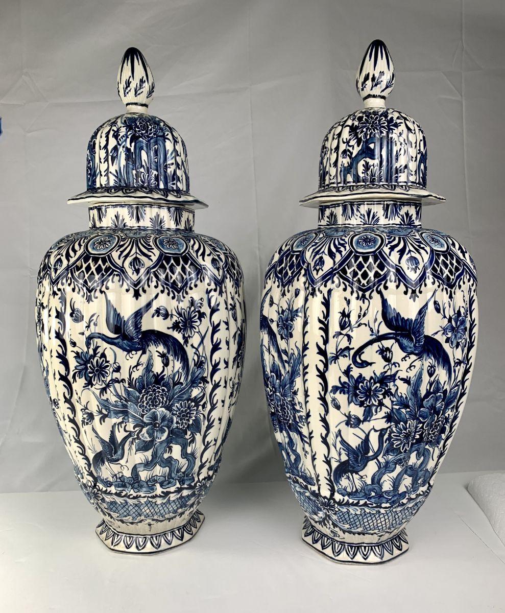 This pair of Dutch Delft blue and white jars is elegant and beautiful.
Made in The Netherlands in the last quarter of the 19th-century, the jars show long-tailed birds in a flower-filled garden.
A variety of beautiful flowers emanates from