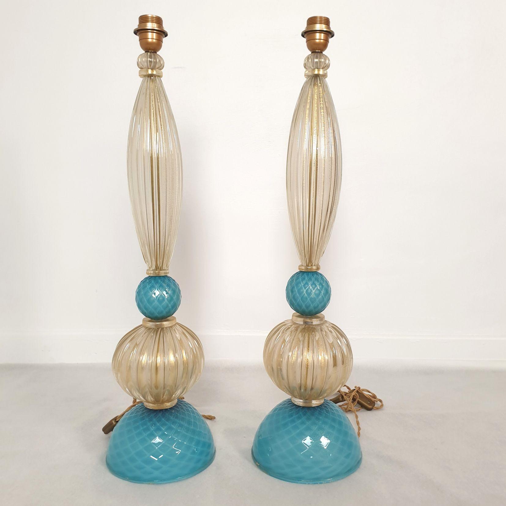 Midcentury large pair of Murano glass lamps, stamped Barovier, Italy 1970s.
The large lamps have a neoclassical style.
They are made of hand blown sky blue and clear with real gold flakes Murano glass elements.
The Murano lamps are stamped: