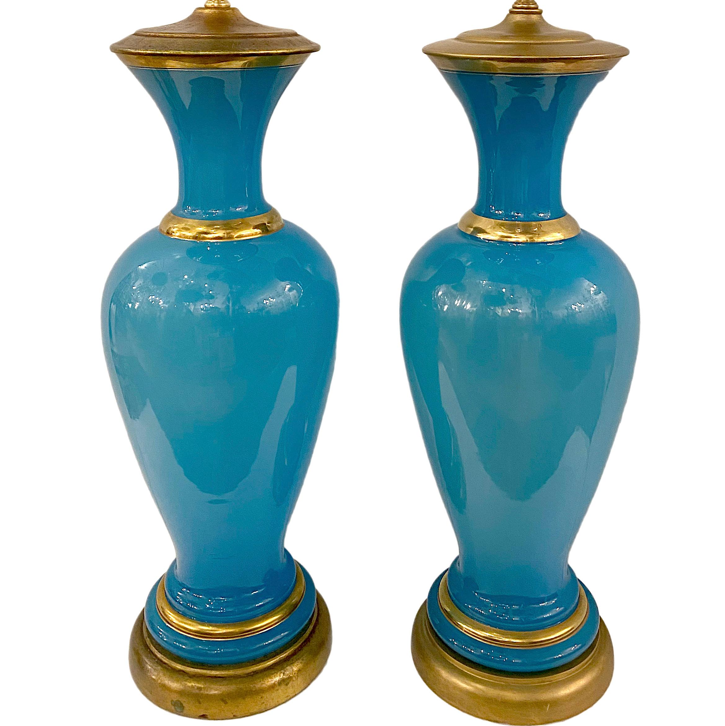 A pair of circa 1930's French blue opaline table lamps with gilt details.

Measurements:
Height of body: 24