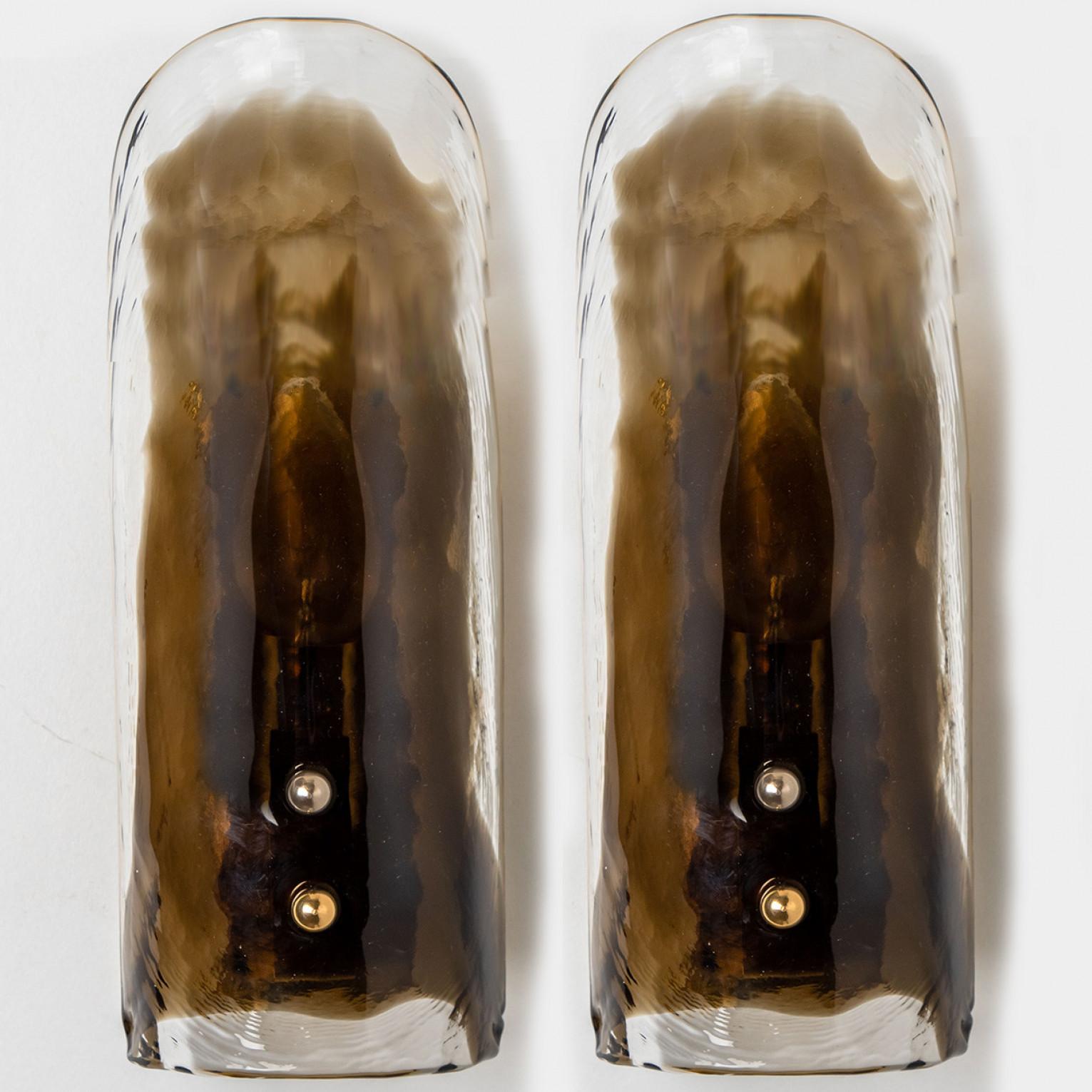 High-end wall sconces made of blown clear and opal Murano glass on a brass hardware. Designed and produced by J.T. Kalmar, Austria in the 1960s. Minimalistic design executed with a taste for excellence in craftsmanship. These are real statement