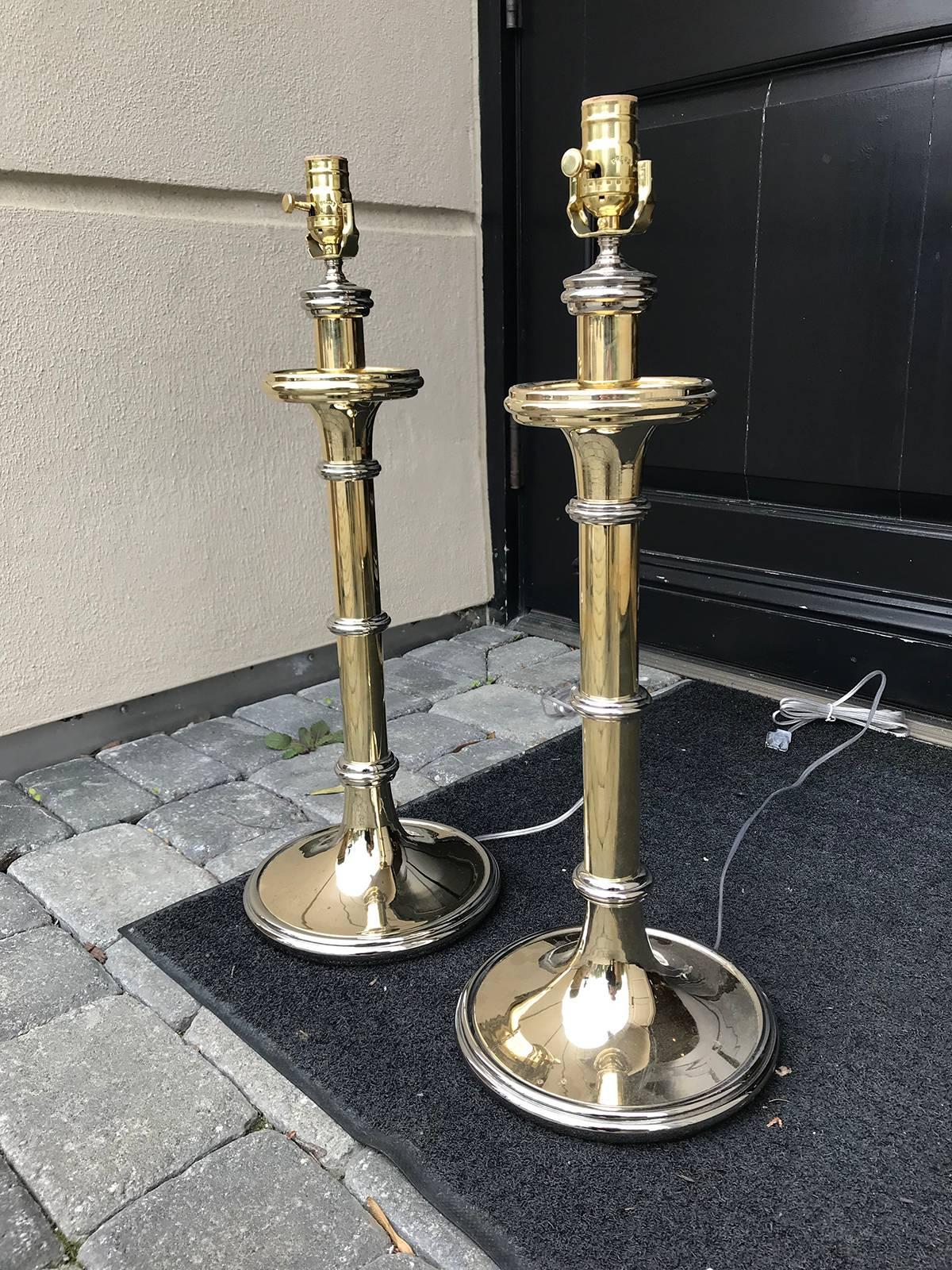 Pair of large brass and nickel candlestick lamps in the style of Chapman.