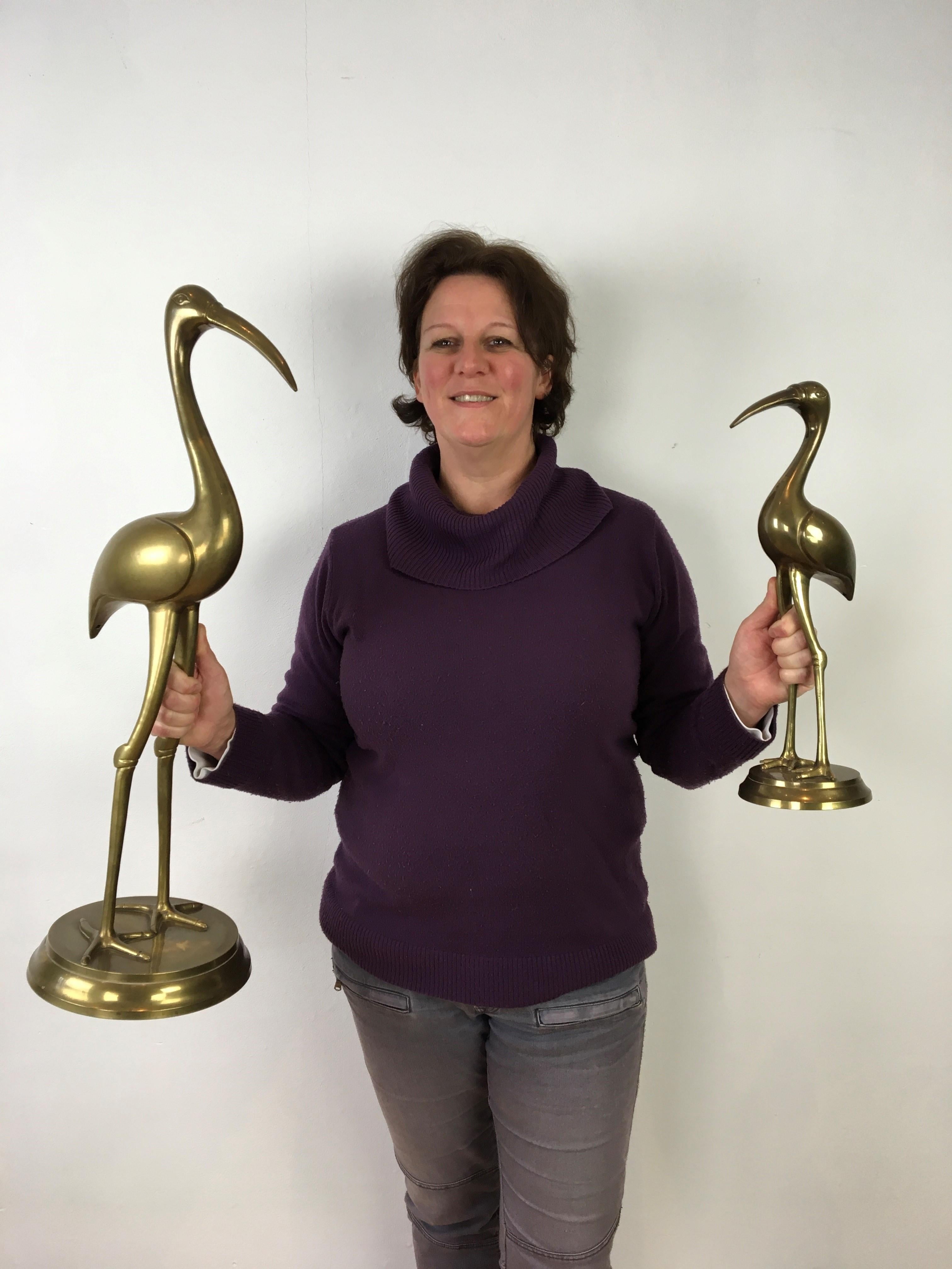 Large brass crane bird sculptures from the 1960s-1970s.
This pair of messing bird sculptures, brass bird sculptures or animal art sculptures does have little patina by age what makes them charming. They are also impressive by their size to decorate