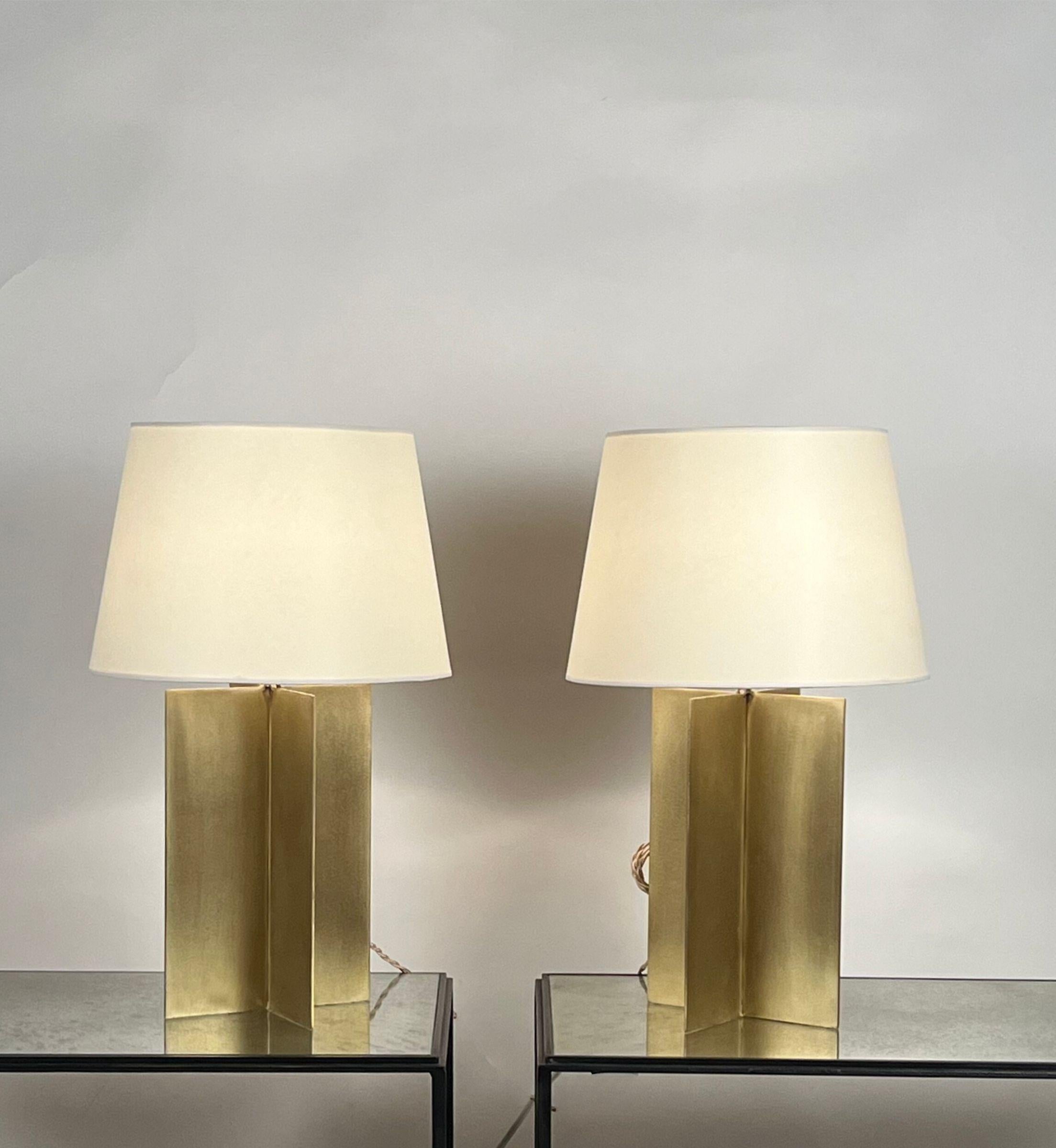 Pair of large brass 'Croisillon' table Lamps with parchment shades by Design Frères®.

An attractive, understated combination of brushed solid brass crosspiece bases with a clear coat and European style parchment shades (no harps or
