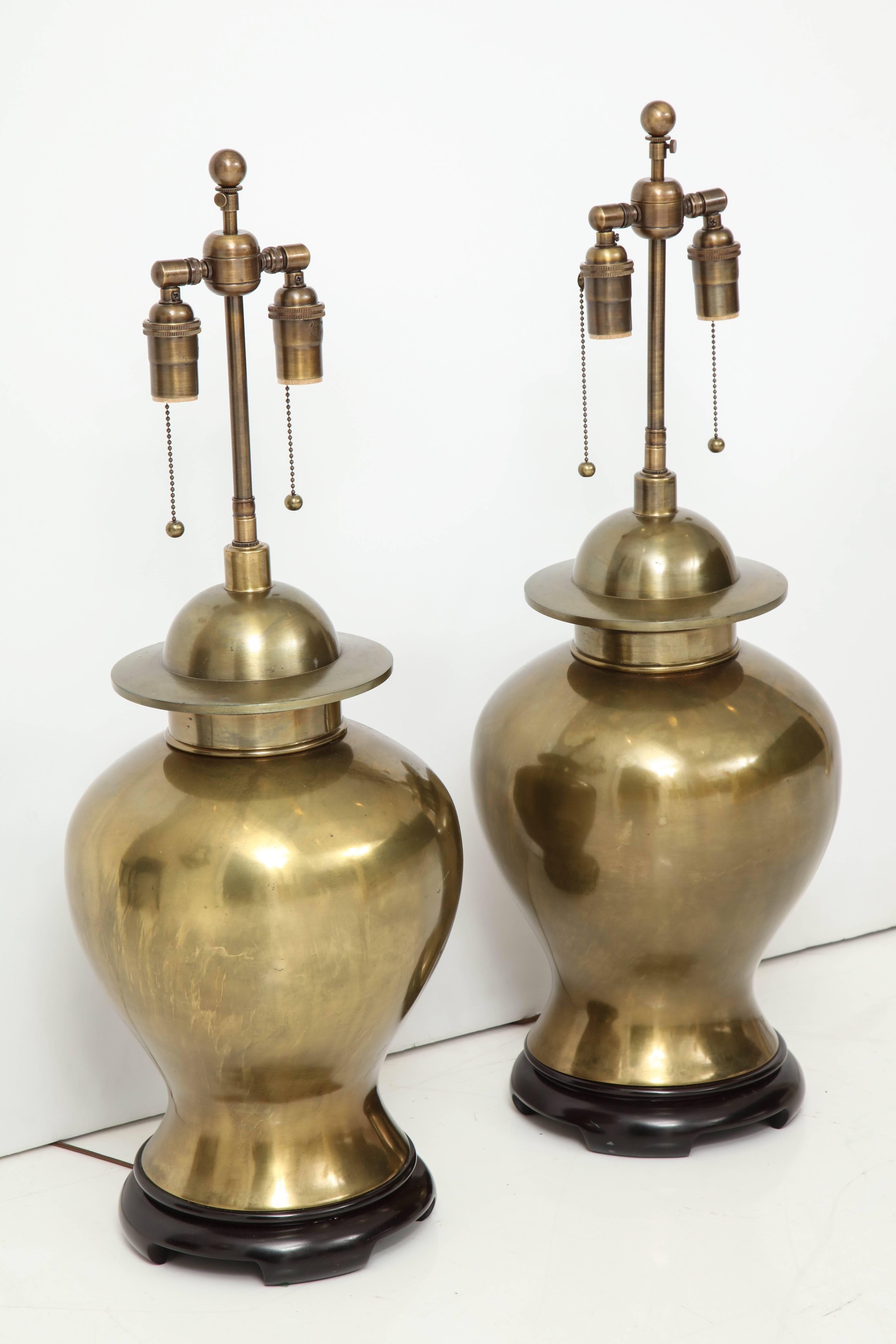 Wonderful pair of large brass ginger jar lamps with a beautiful patina.
The lamps have a significant weight to them and are newly rewired with polished antique brass double clusters that take standard light bulbs.
The overall height of the lamps