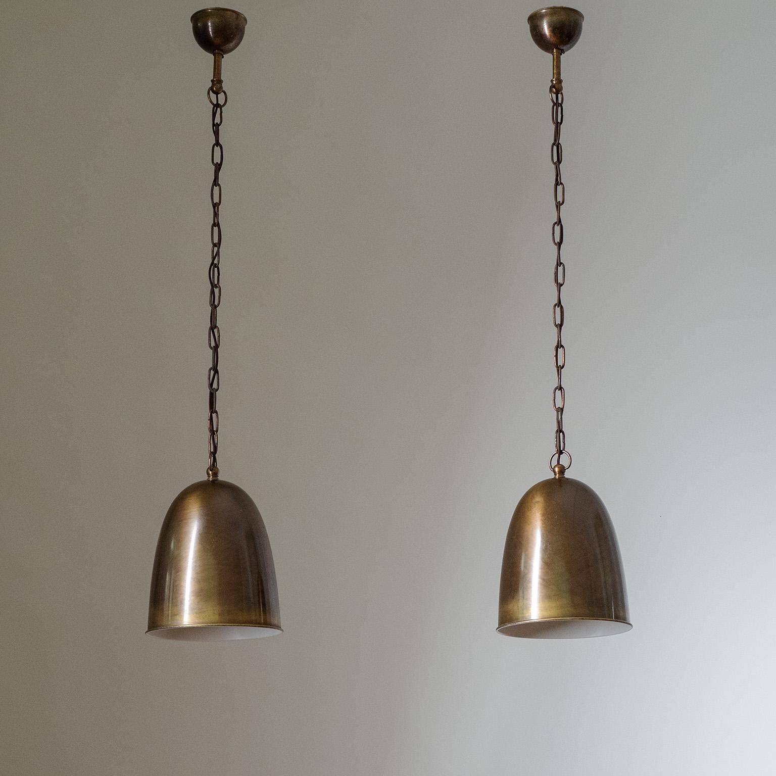 Fine pair of brass pendants from the 1930s. All brass construction with a bell-shaped shade. Nicely aged patina throughout with new paint to the inside of the shades. One original brass and ceramic E27 socket with new wiring. Body Height 28cm