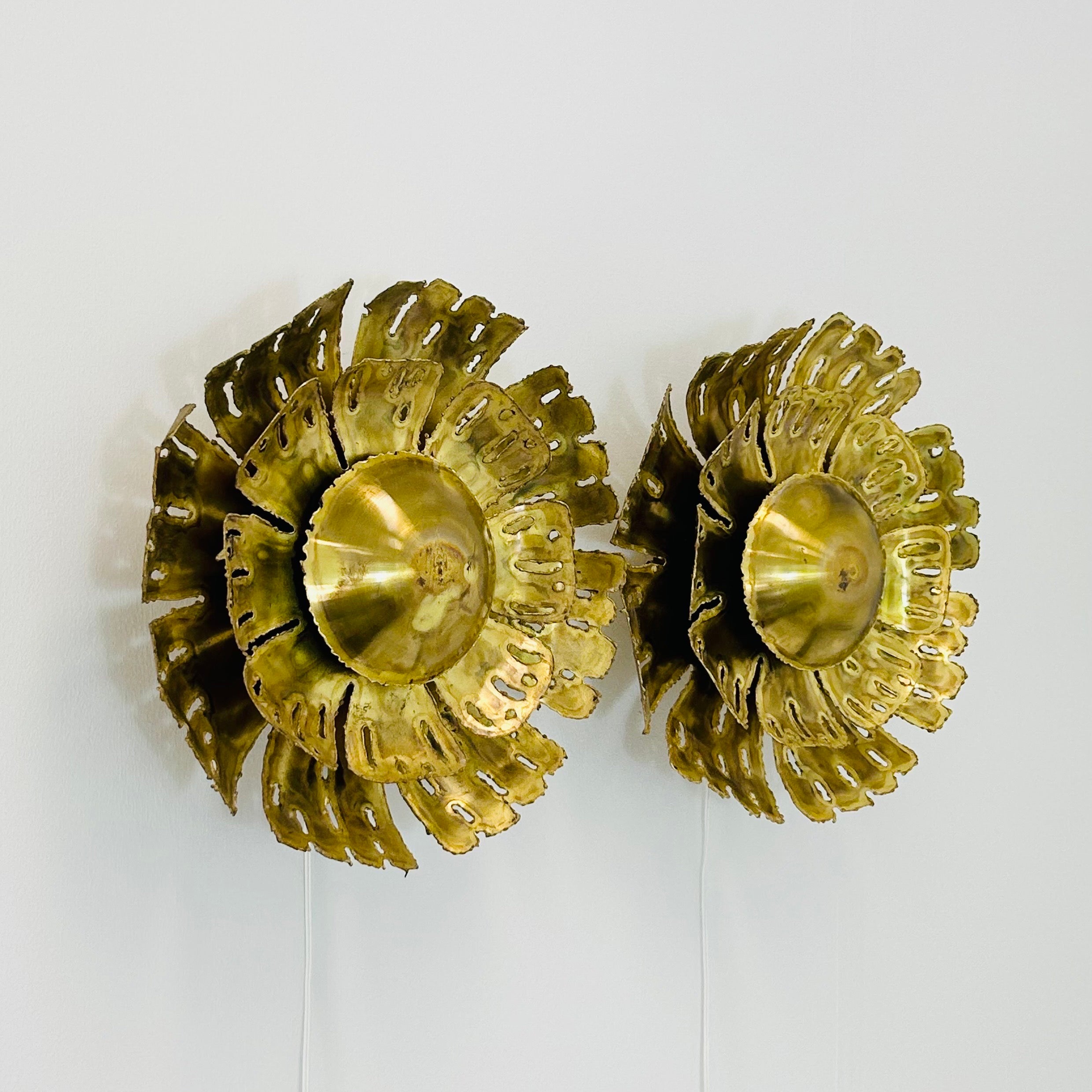 A pair of substantial sun-shaped brass wall lamps designed by Svend Aage Holm Sørensen in the 1960s. Produced by his company Holm Sørensen & Co., this eye-catching style no. 5207 is a true masterpiece and trademark of the Danish designer. Finding a