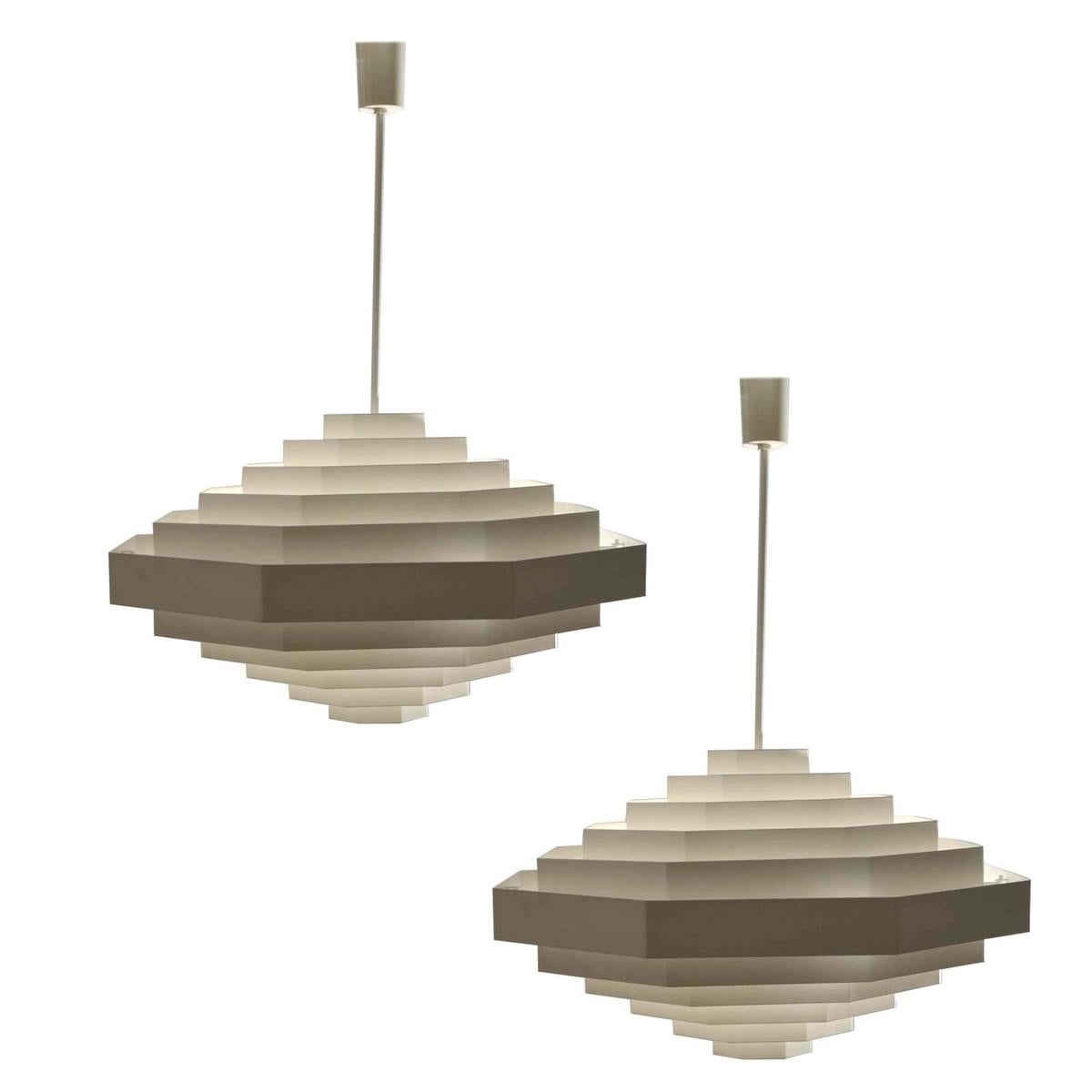 Two large white octagonal chandeliers (diameter 70 cm) are made in metal strips of enameled metal cascading in both vertical directions, 1970s Spectral Germany. They look like gigantic floating diamonds. The light is diffused by the layers of
