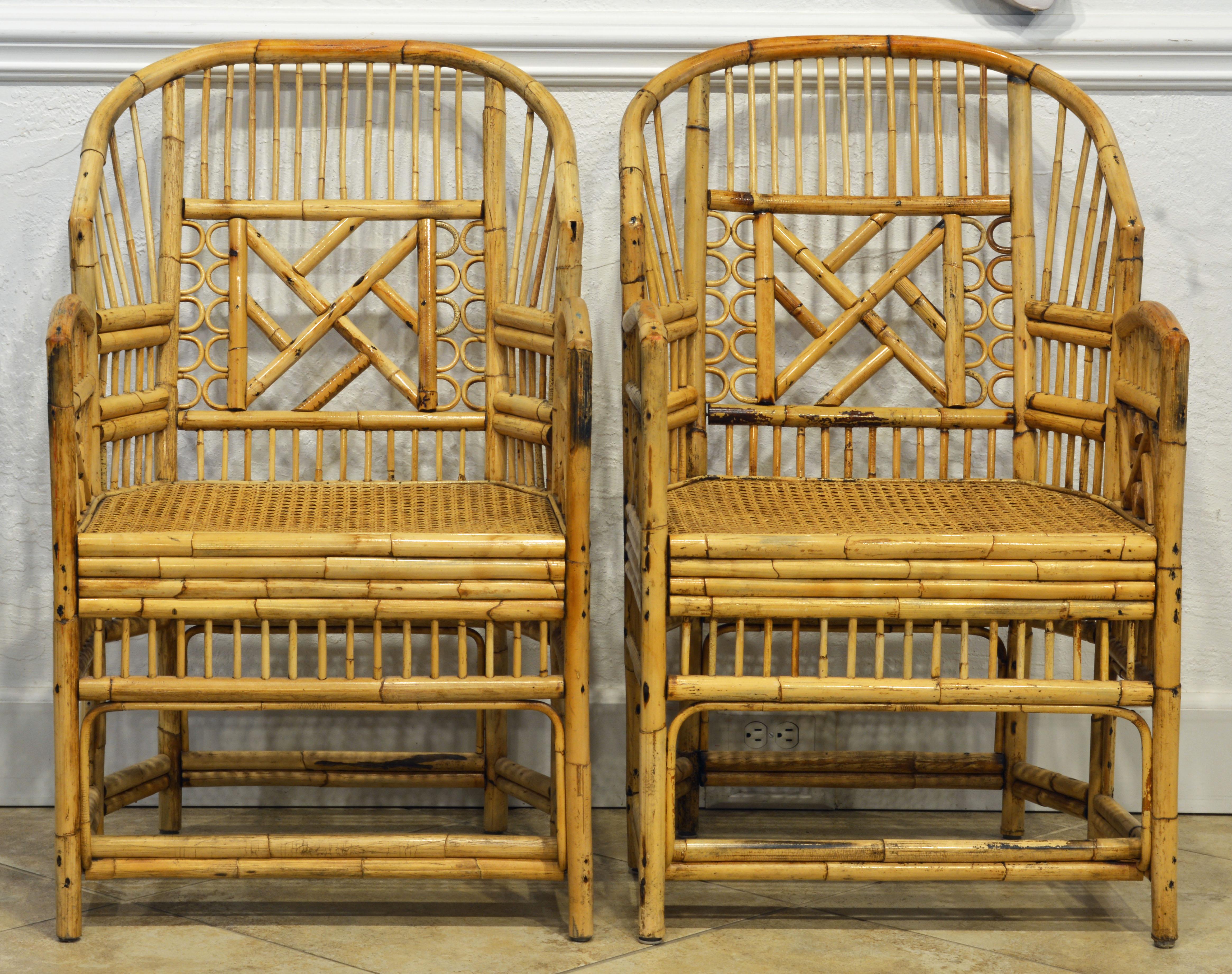 Rising on six legs these intricately crafted iconic vintage armchairs with cane seats of an extra large size feature bamboo frames and Chinese themed bamboo open work inspired by Chippendale design. The larger size and the bold handcrafted style add
