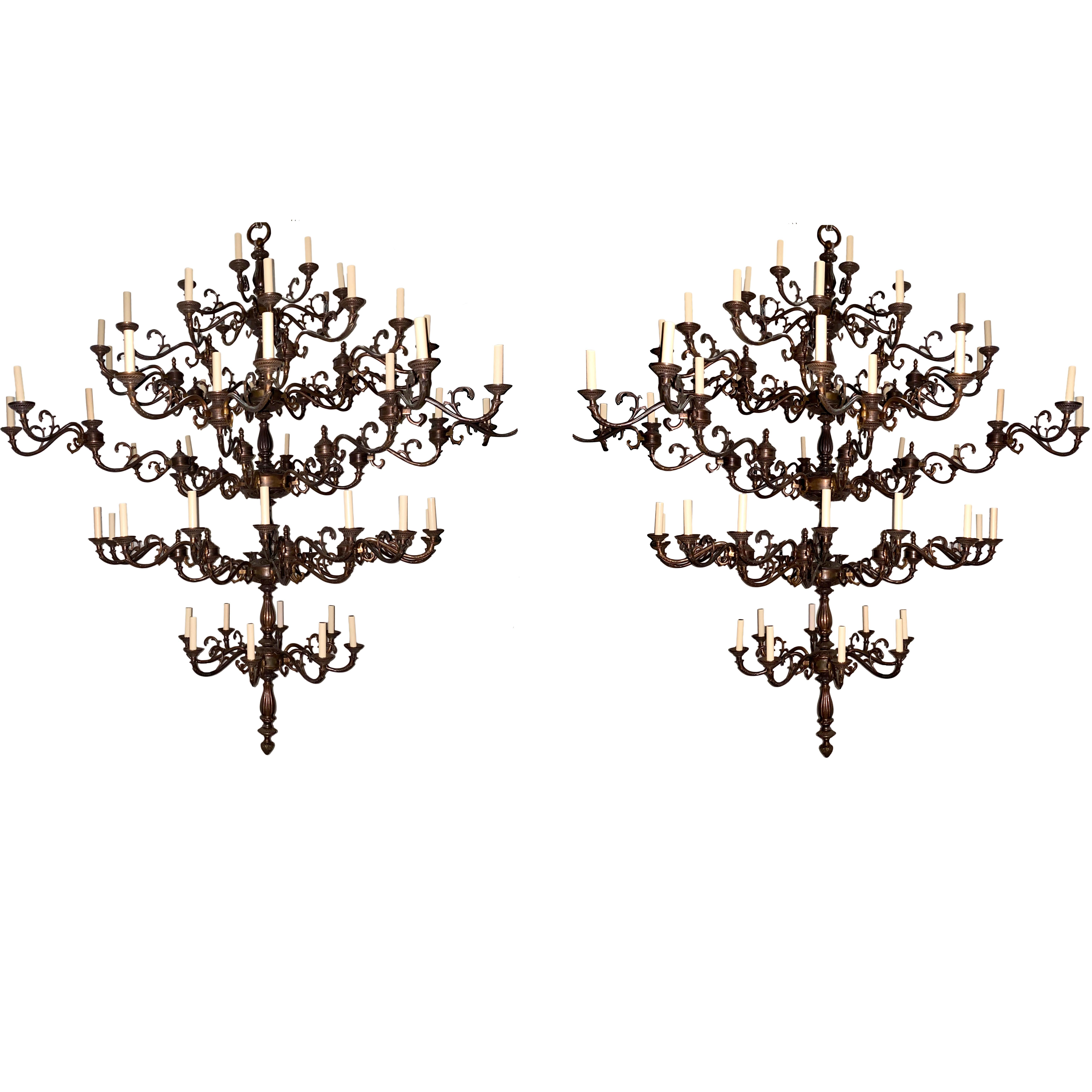Pair of circa 1940s French bronze chandeliers with 72 lights each, 
six tiers, original patina. 
Rewired for use in US

Measurements:
Drop 78