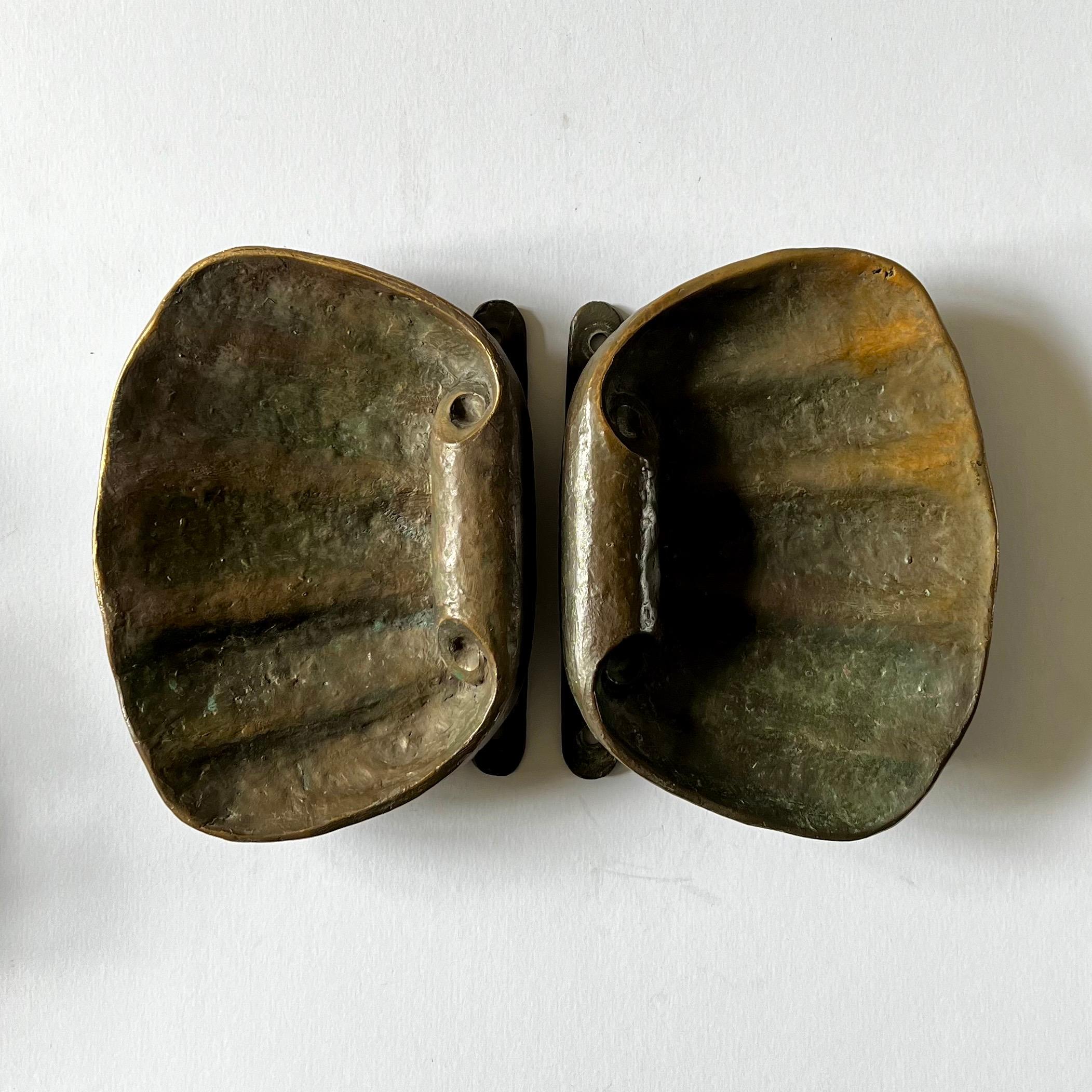 A set of two very large bronze door handles in the shape of seashells. 20th century, European.

The handles are impressive pieces, each of the same organic design, which can be turned to use on the left or right as required. Cast to include the