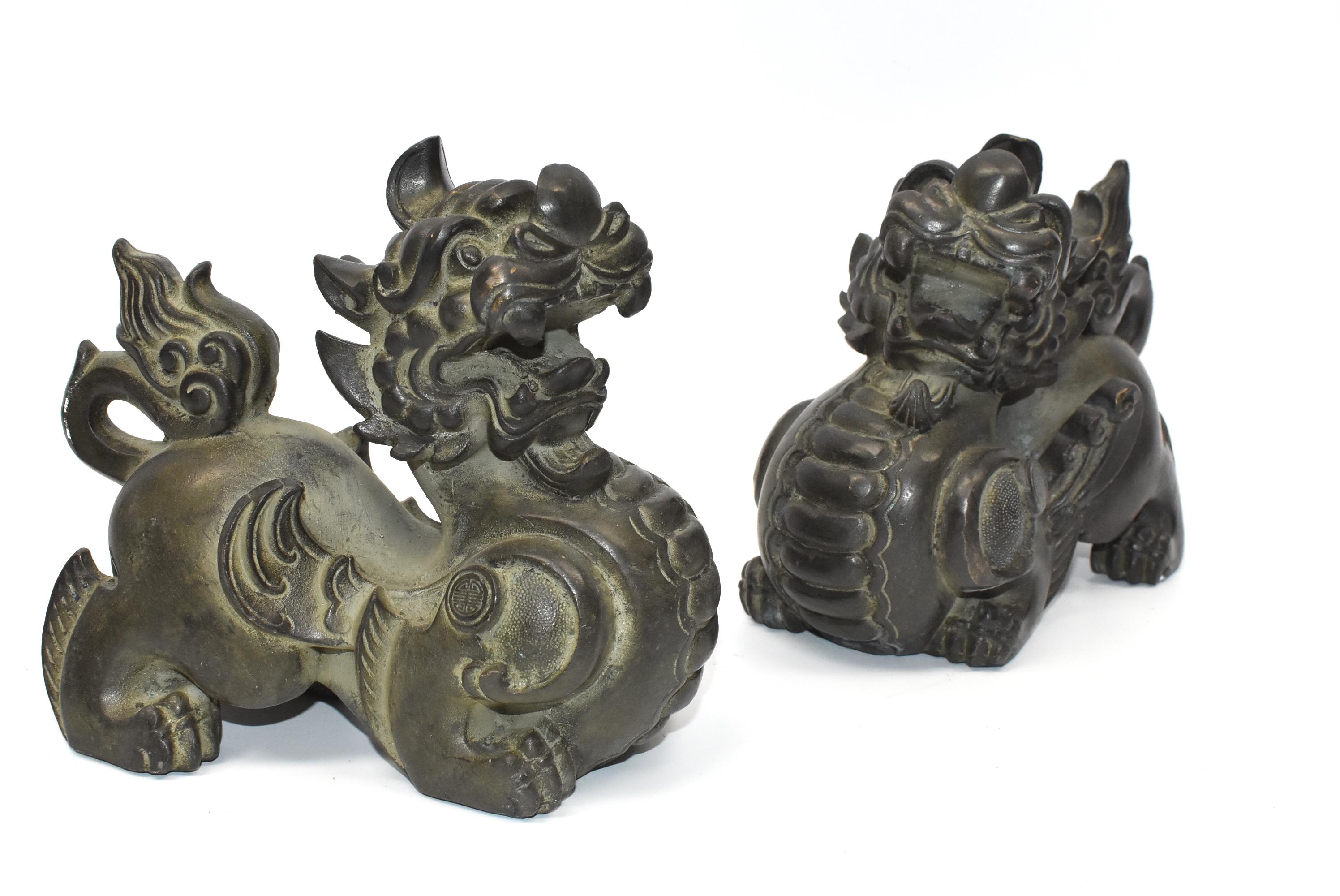 A pair of beautiful bronze Pixiu winged lions. These are mythical beasts believed to bring and keep tremendous wealth. Fine craftsmanship and vivid expressions. Detailed works throughout. They are fantastic sculptures and make great doorstops and