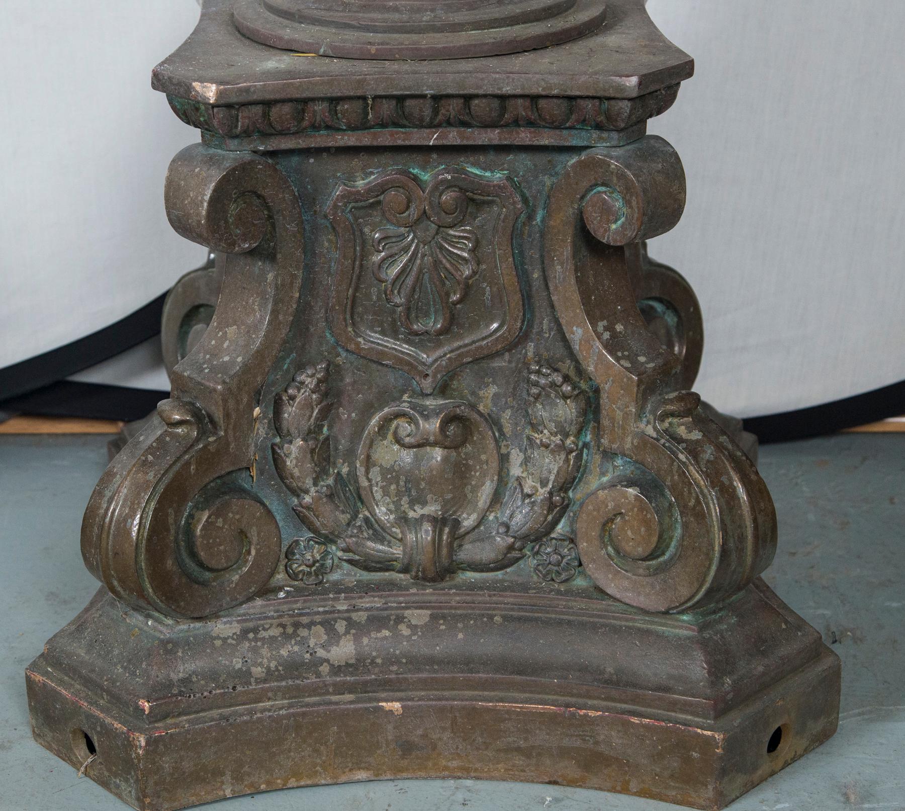 Magnificent bronze torchieres standing over 8 feet tall. Olde world craftsmanship at its finest. One has been polished and is missing a plate (see initial photo on left). The other has a wonderful patina finish. Globes are not original to these