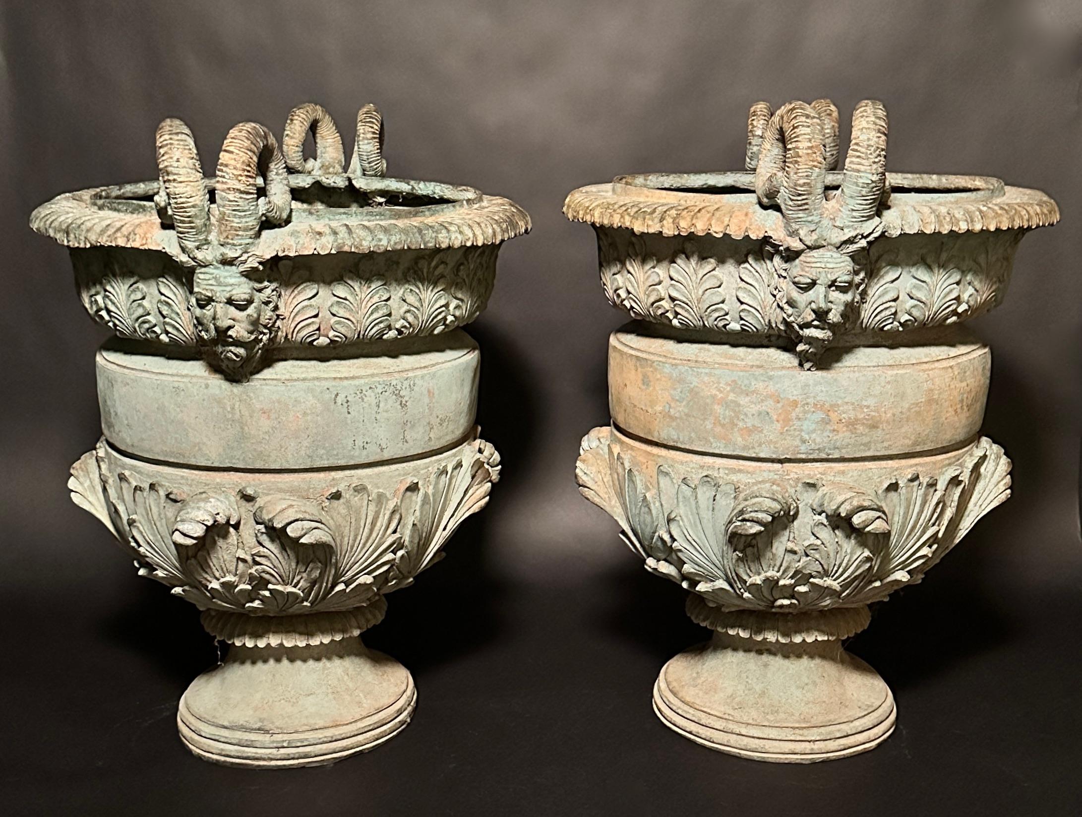 Beautiful pair of verdigris patinated bronze planters in the Grand Tour style. Decorated with acanthus leaves and scrolls and Satyr head mounted handles on either side.