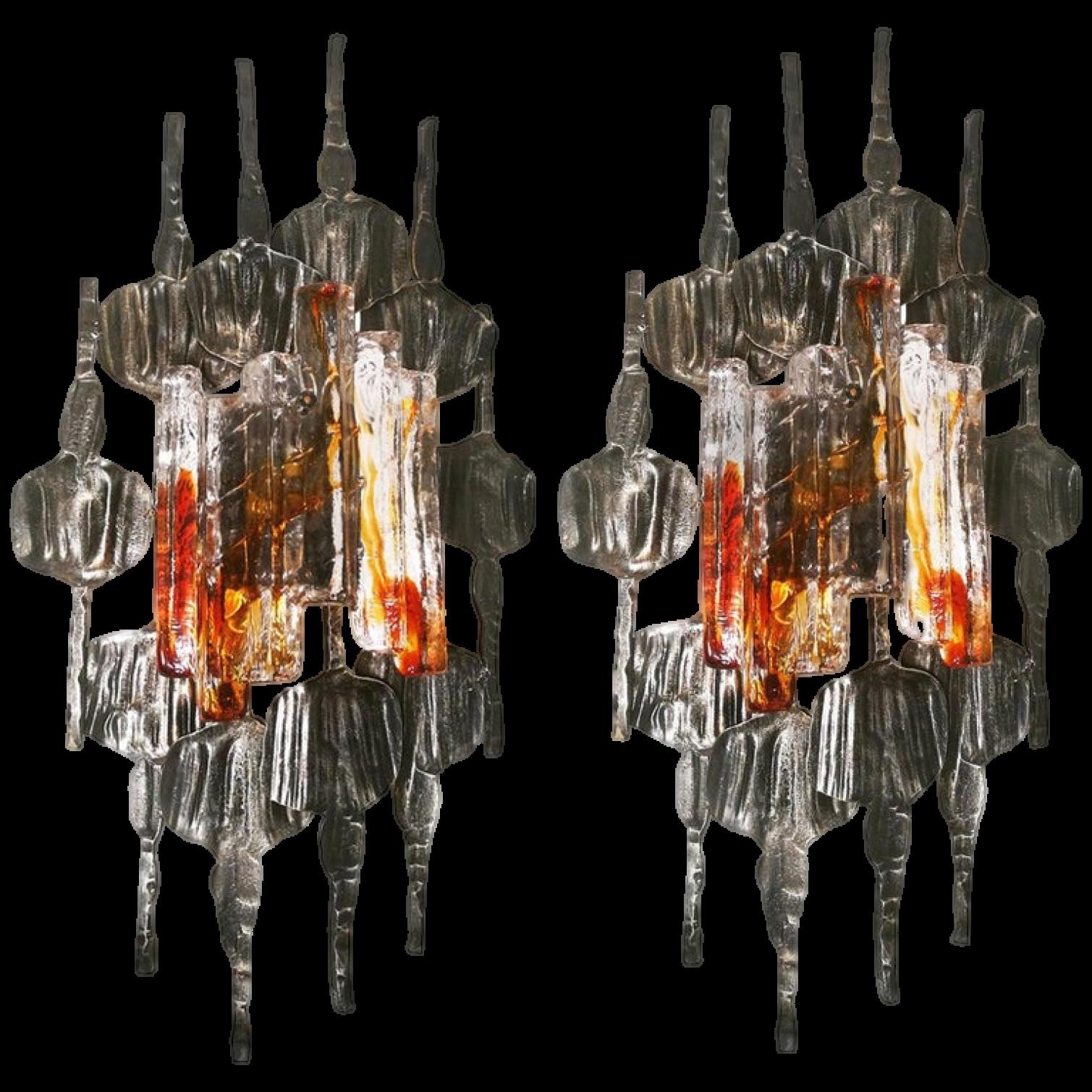 A large pair of Brutalist wall sconces by Tom Ahlström & Hans Ehrlich, Sweden, 1960s, each with a E27 bulb.
A absolute strong and sculptural design!

The hand wrought iron surround has a good patination and is set off by the Murano ice glass with