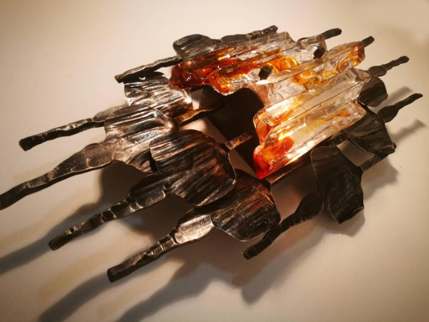 A large pair of Brutalist wall sconces by Tom Ahlström & Hans Ehrlich, Sweden, 1960s, each with a E27 bulb.
A absolute strong and sculptural design!

The hand wrought iron surround has a good patination and is set off by the Murano ice glass with