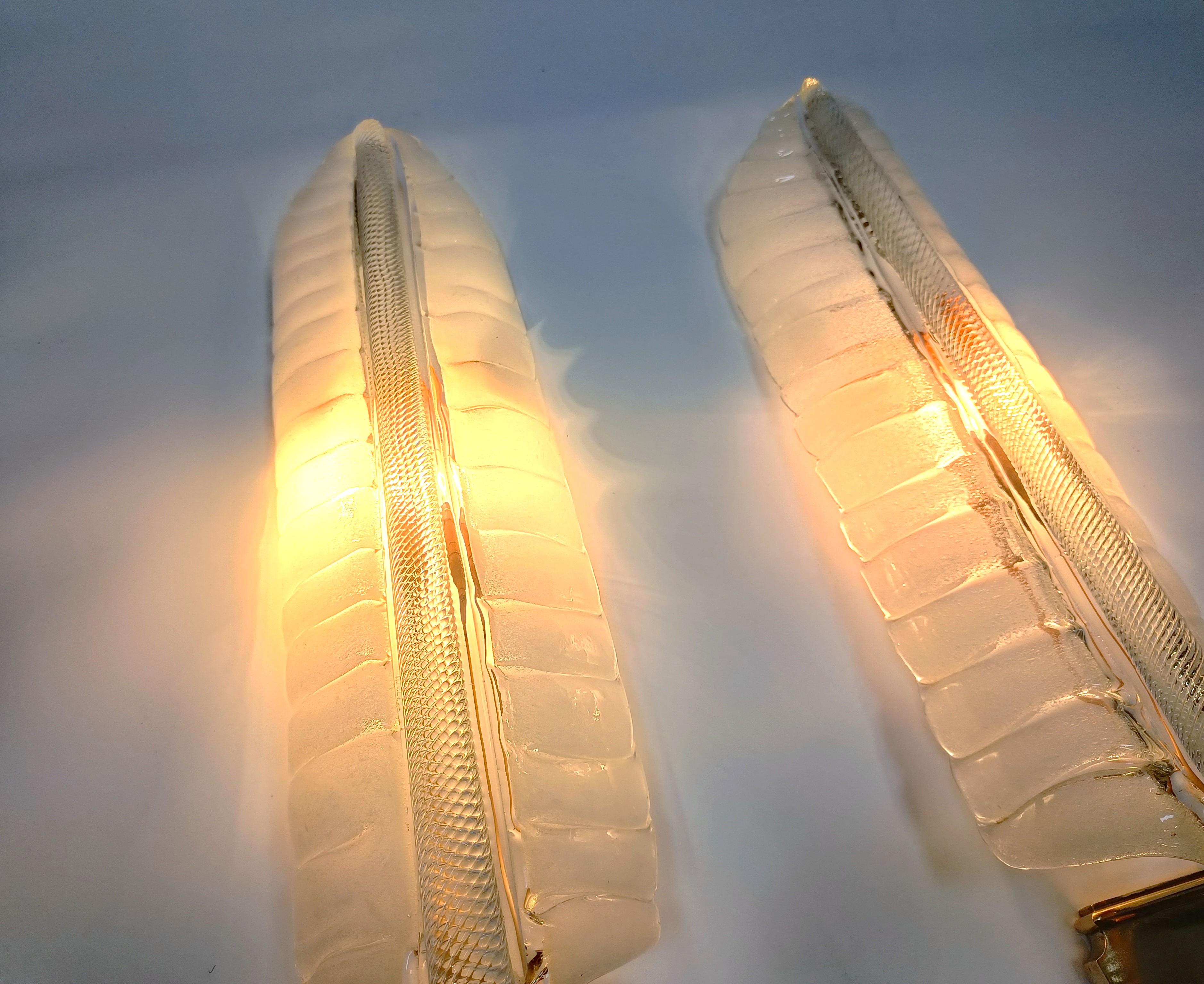 
Pair of crystal 'feather' wall lamps by André Arbus & Veronese, hand made with brass glass holders.

The glass work is incrediblky detailed and on top of that emits a nice warm and diffuse light.

These well lamps are massive in size and are real