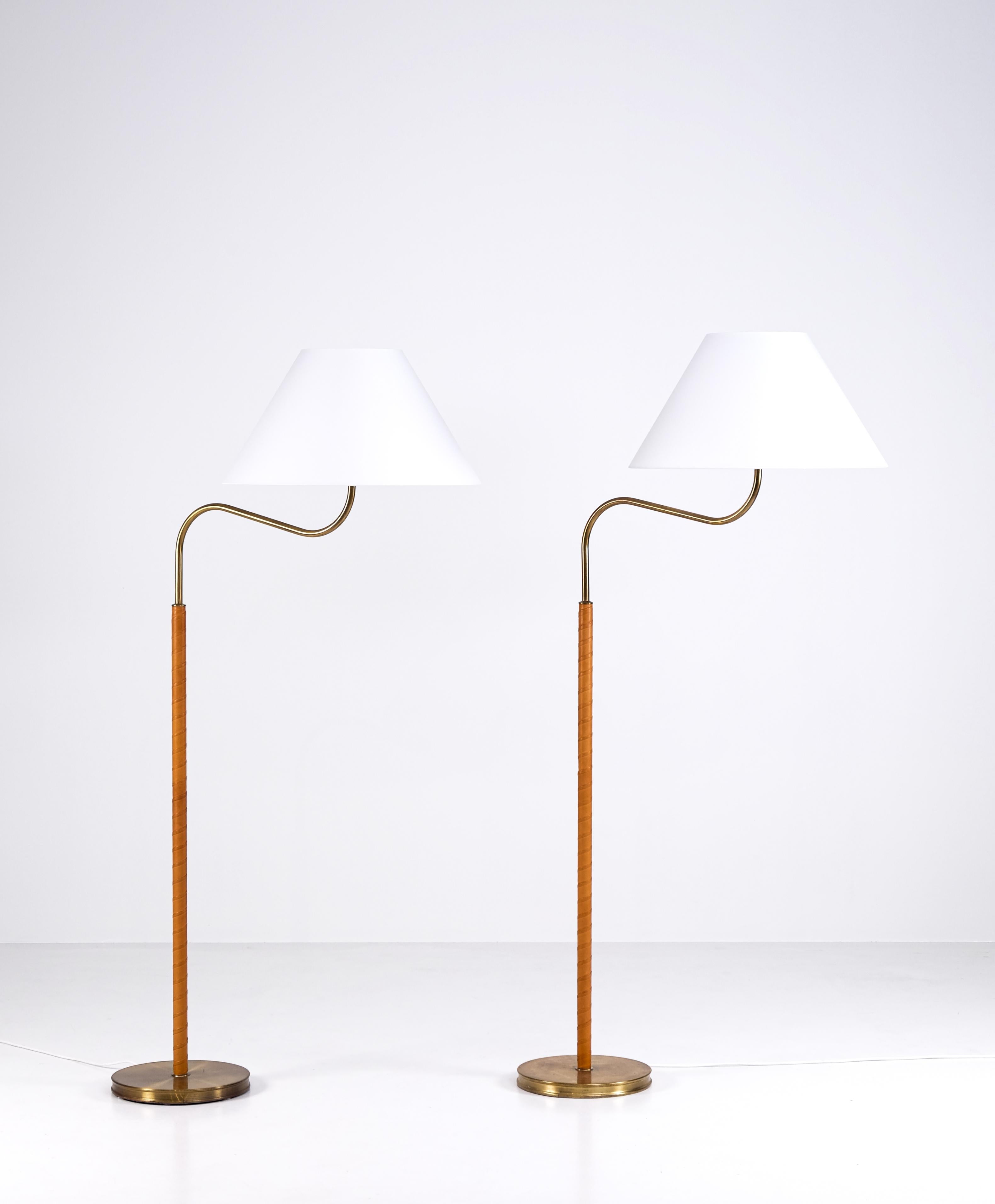 Designed by Josef Frank in 1939, this pair produced circa 1960s. 
New leather and new original Svenskt tenn lampshades.