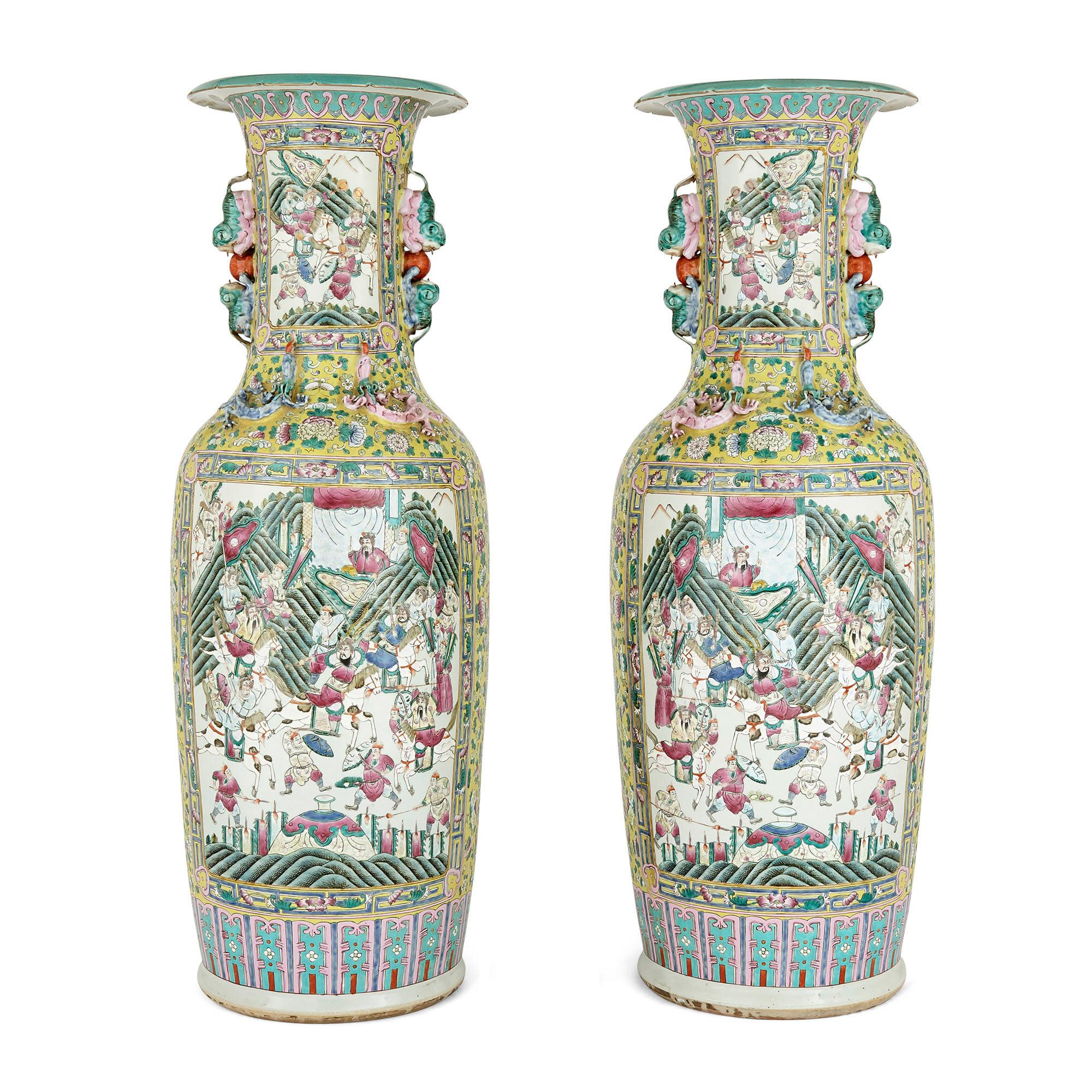 Pair of large Canton style Chinese porcelain vases
Chinese, early 20th century
Measures: Height 123cm, diameter 42cm

These large and impressive Chinese famille jaune porcelain vases are elaborately decorated with various Chinese motifs. Each