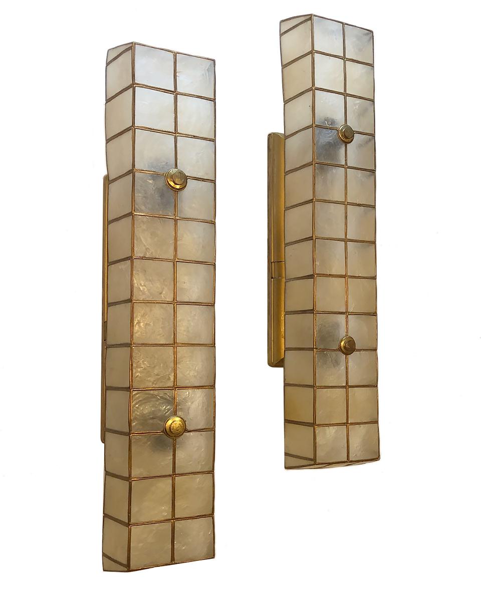 A pair of large circa 1950s French capiz shell sconces with brass details and backplate with four interior lights each.

Measurements:
Height 23