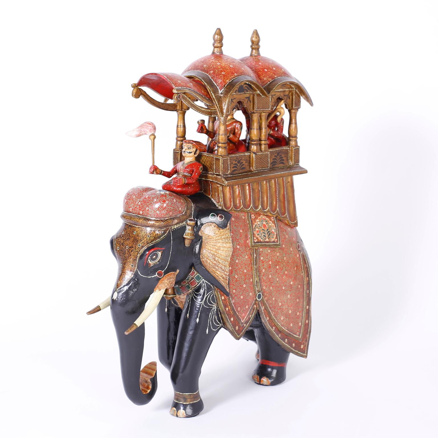 Pair of antique Anglo-Indian elephant taxis carved in indigenous hardwood and polychromed with ambitious detail. Featuring carved and painted drivers and passengers riding fanciful saddles and having a striking generous scale. Best of the genre.