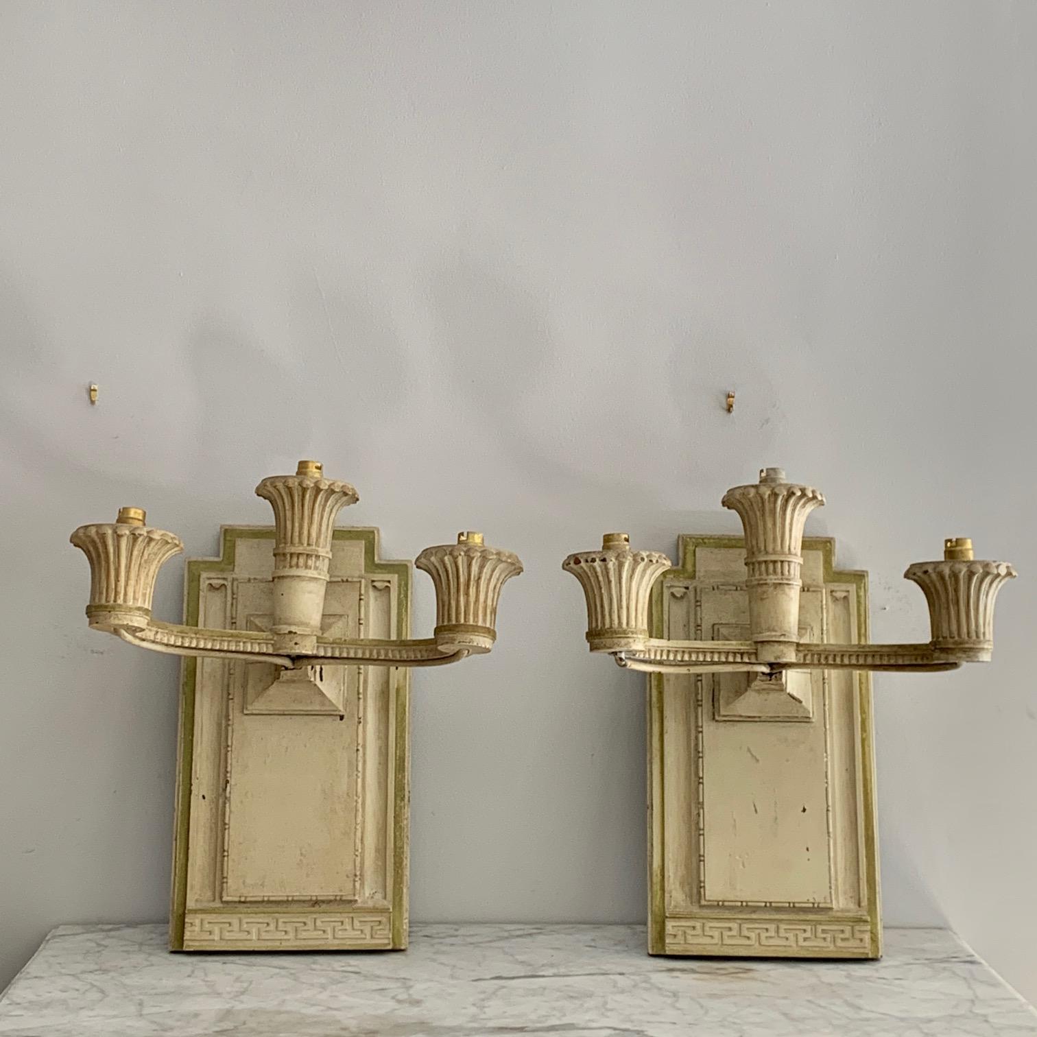 Pair of wall sconces in carved wood and painted in gray with three lights each, in a neoclassical style.