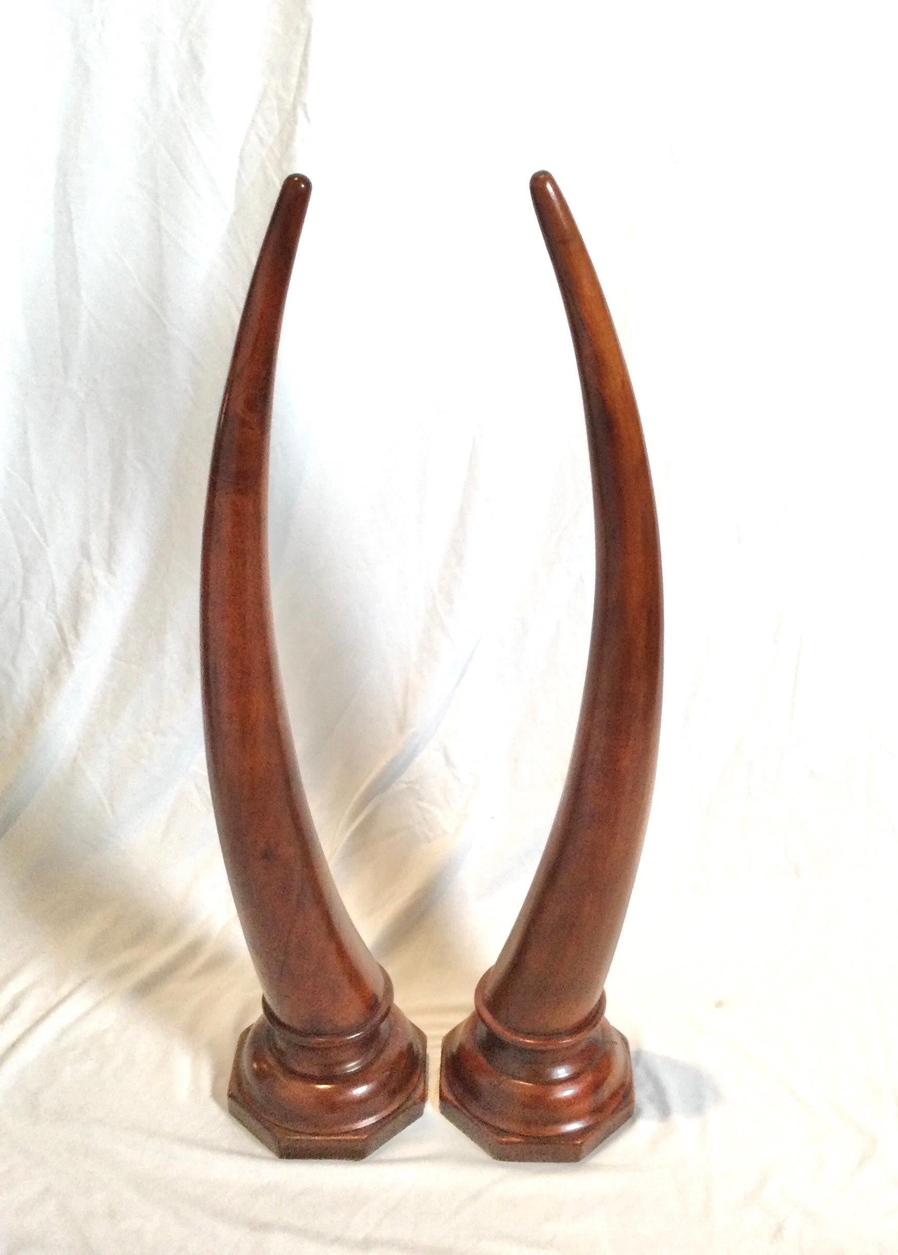 Pair of large carved mahogany tusks. 35