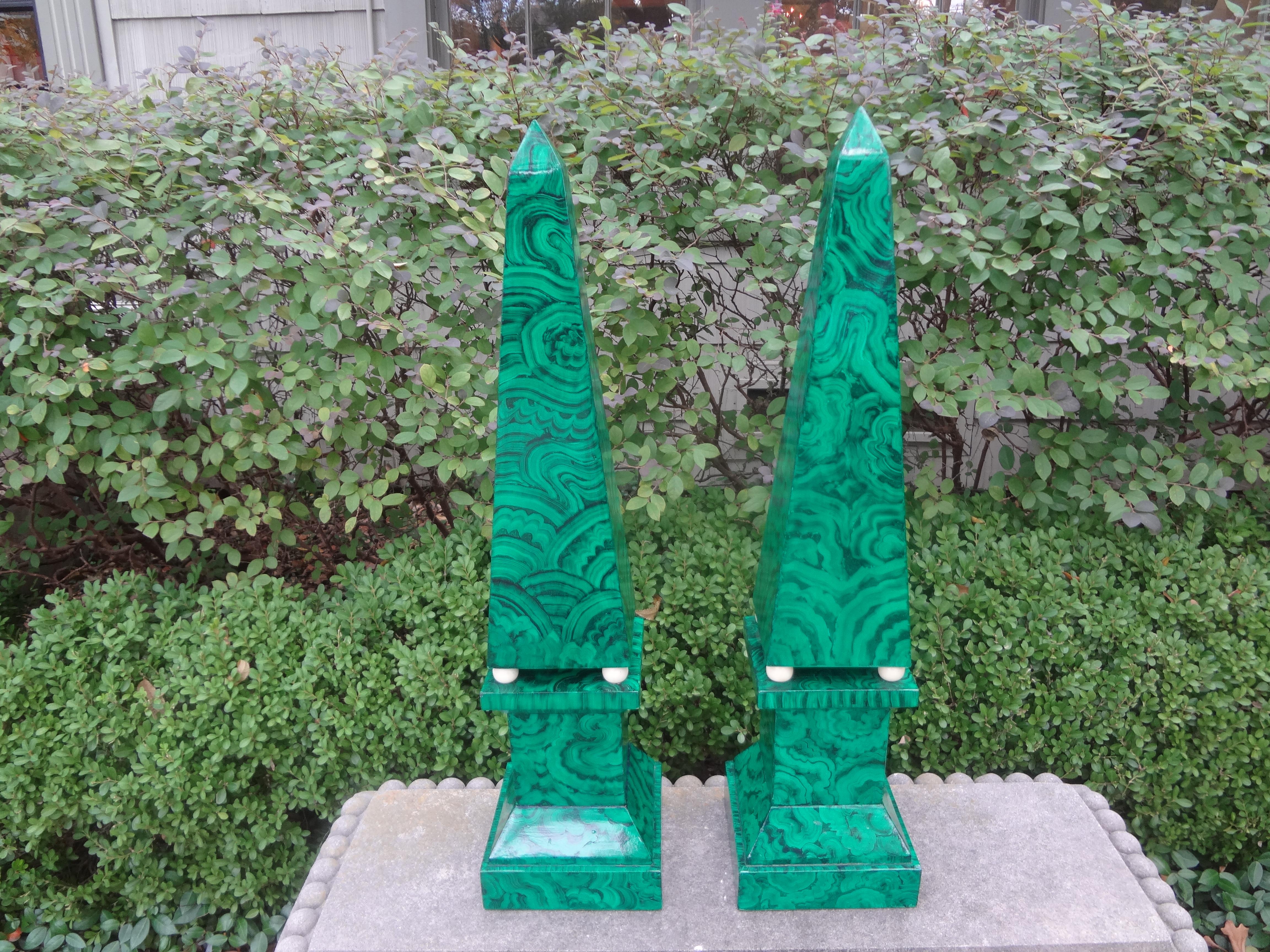 Pair of large carved wood faux Malachite Obelisks.
Offered is a stunning pair of Hollywood Regency style carved wood obelisks. This pair of large scale hand decorated neoclassical faux malachite obelisks are statement pieces.