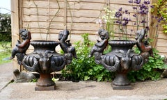 Pair of Large Cast Iron Garden Urns with Rams and Putti