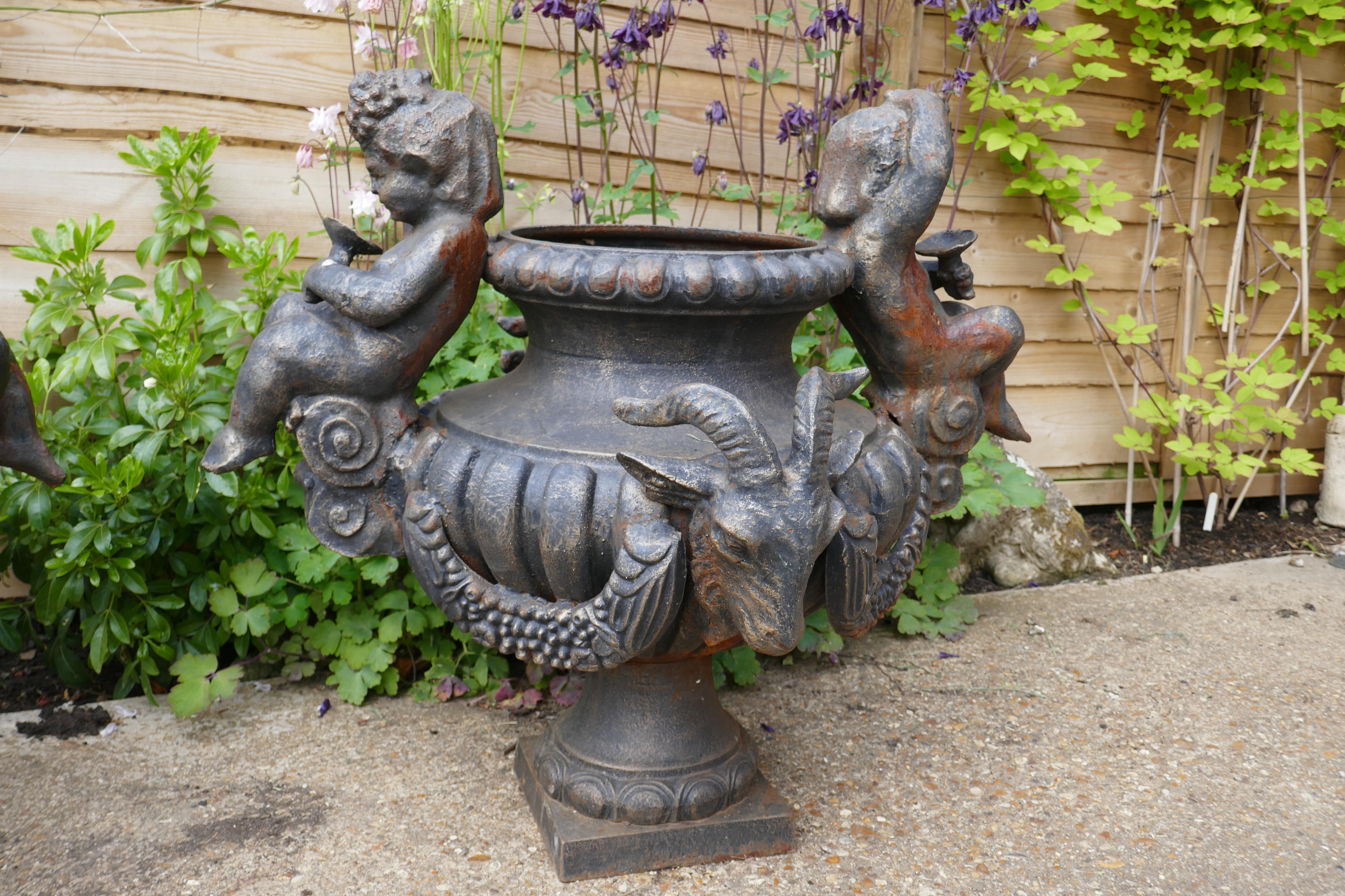 Grand Tour Pair of Large Cast Iron Garden Urns with Rams and Putti For Sale