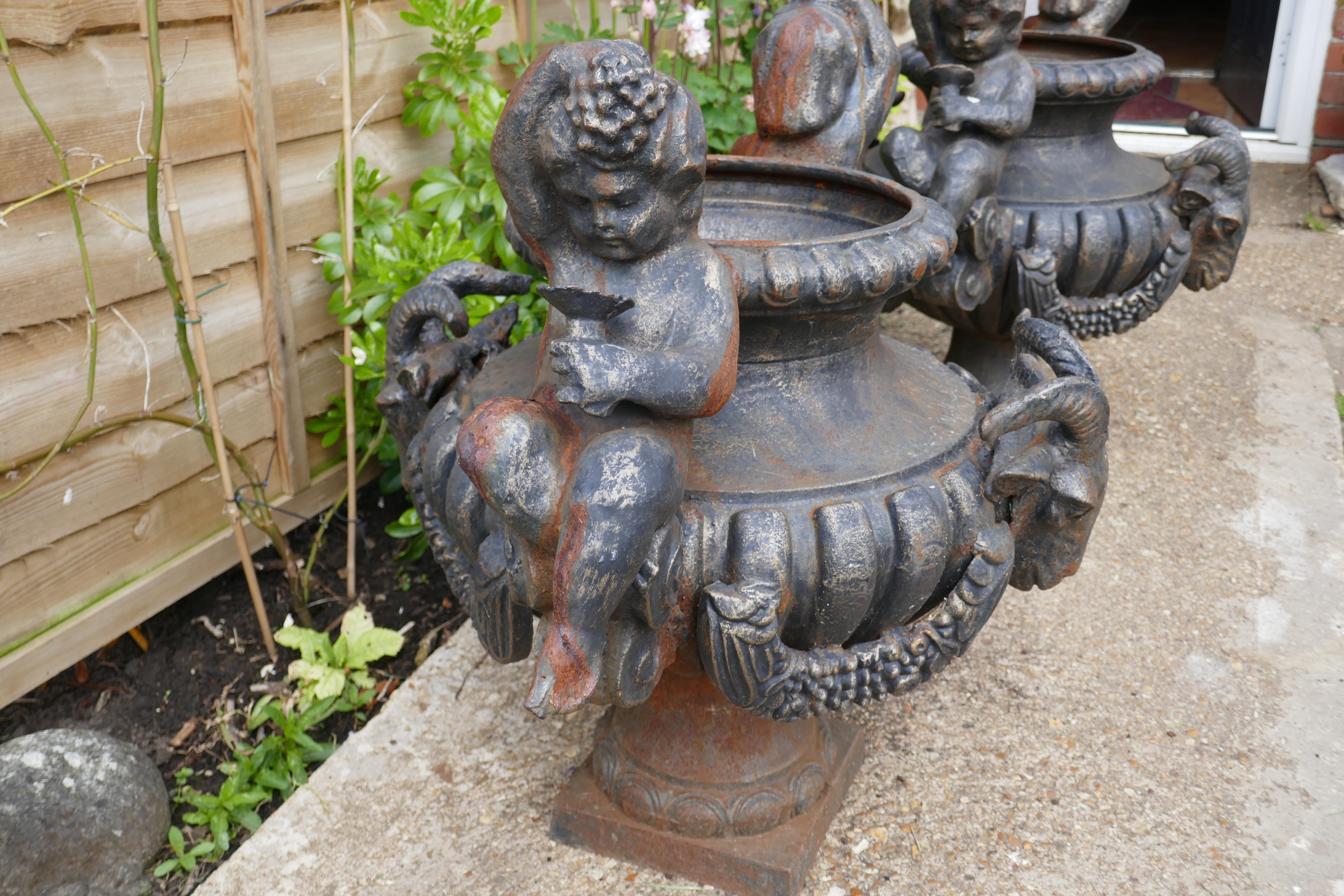Early 20th Century Pair of Large Cast Iron Garden Urns with Rams and Putti For Sale