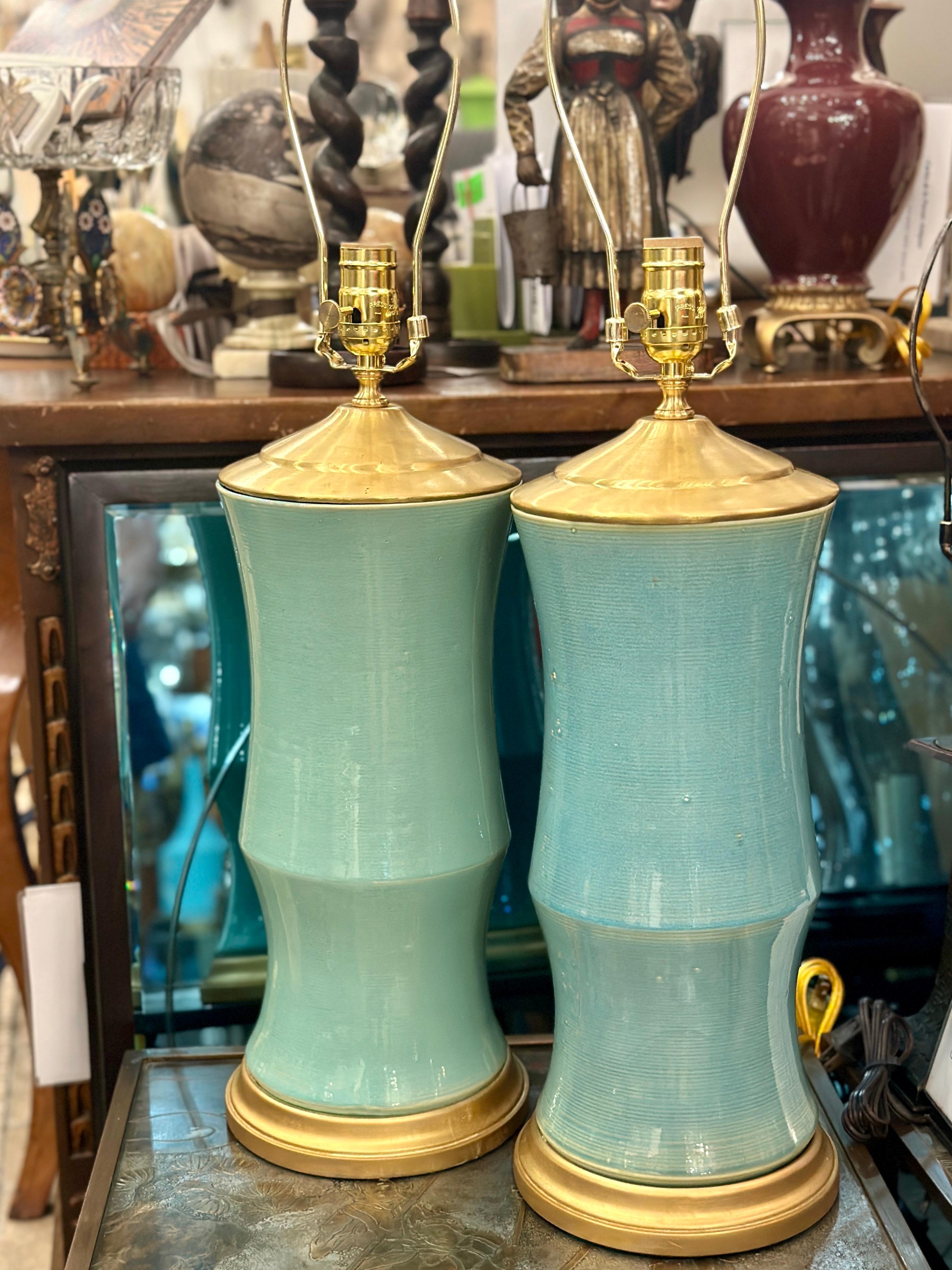 Pair of midcentury circa 1950’s Chinese celadon porcelain table lamps with gilt bases

Measurements:
Height of body: 18″
Height to shade rest: 28″
Diameter: 7.5″