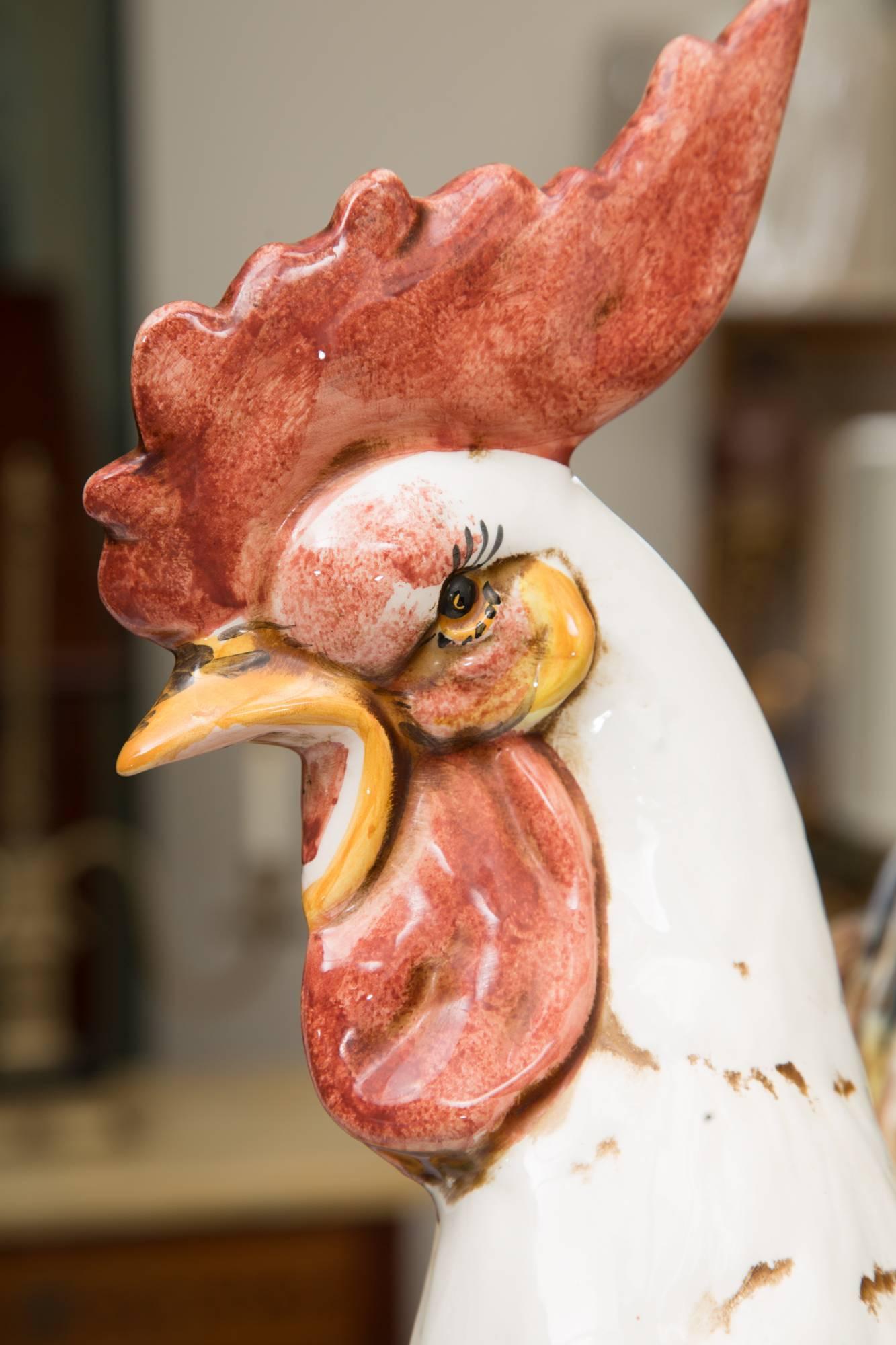 This large and stunning pair of ceramic hand-painted cocks are deigned in a naturalistic setting. Beautifully painted in realistic coloring and glazed; these Italian figures offer an impressive home accent, 20th century.