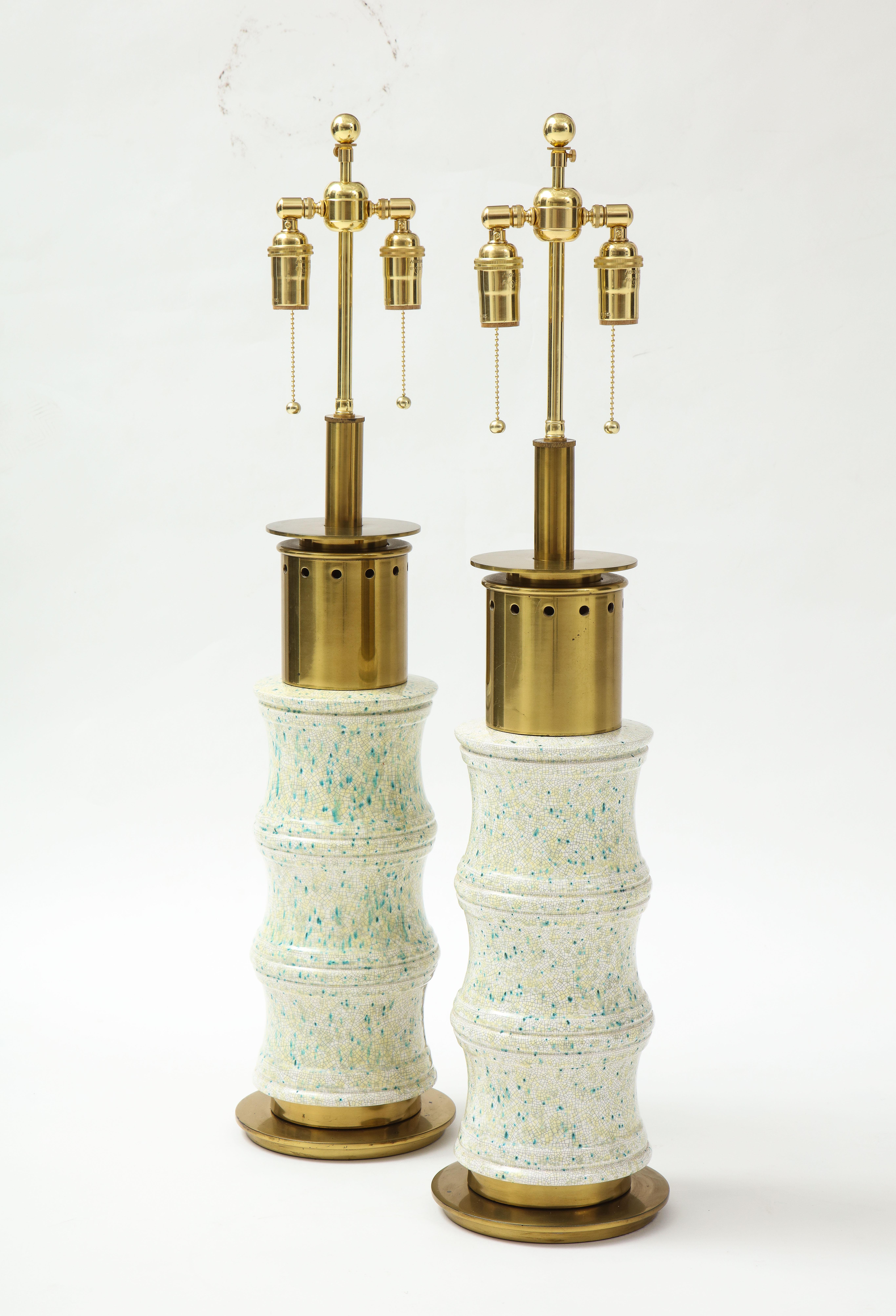 Pair of Large ceramic lamps by Stiffel lamp company.
The ceramic lamp bodies have a paint splattered crackled glaze finish.
The lamps have brass hardware with a beautiful patina and they have been Newly rewired with adjustable brass double clusters