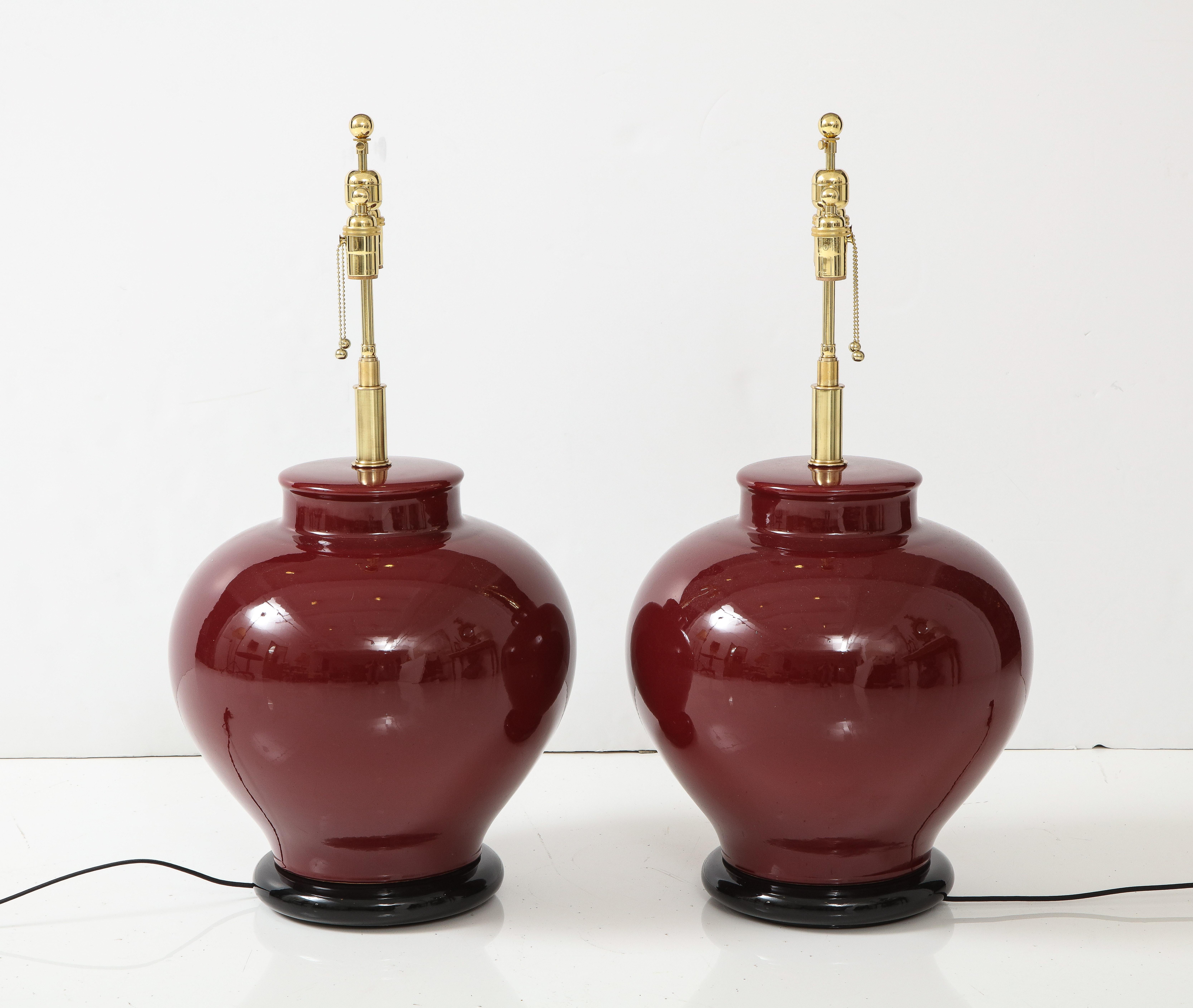 Brass Pair of Large Ceramic Lamps with a Rich Burgundy Glaze Finish For Sale
