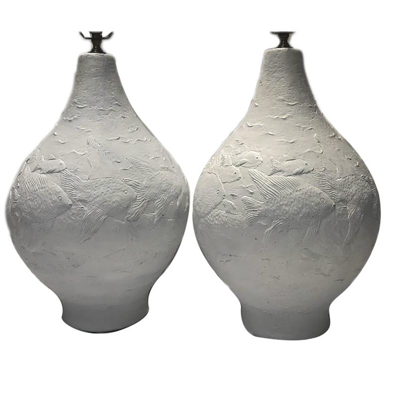 Pair of large circa 1960's Italian white textured Italian midcentury ceramic table lamps depicting fish.

Measurements:
Height of body 19.5”
Diameter at widest 13”.