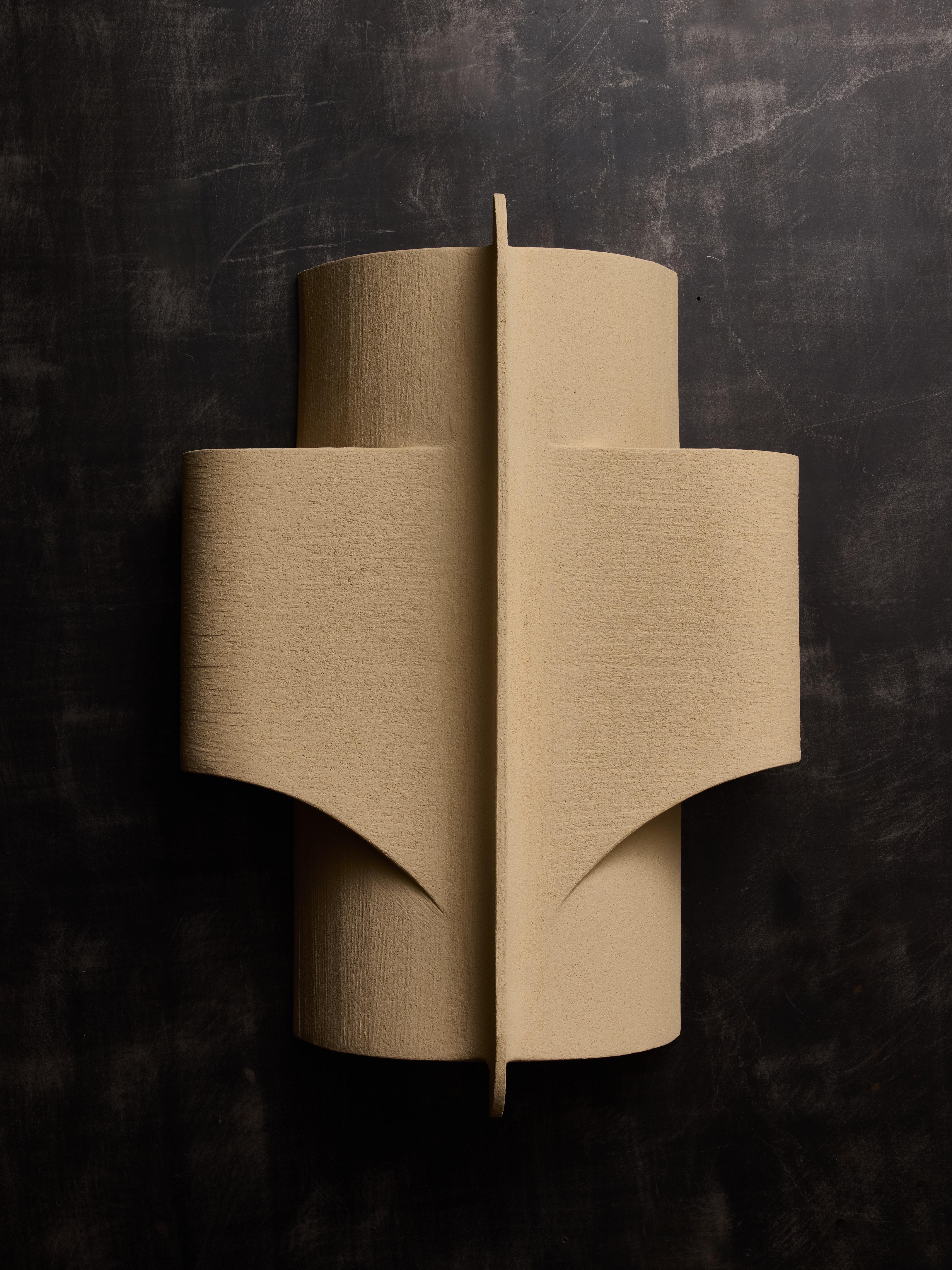 Large white sandstone ceramic wall sconces created by Olivia Cognet. The soft curves and openings of the design enable light to gently filter through the sconce, producing an elegant ambient glow.
Signature of the artist on the back

Since moving to