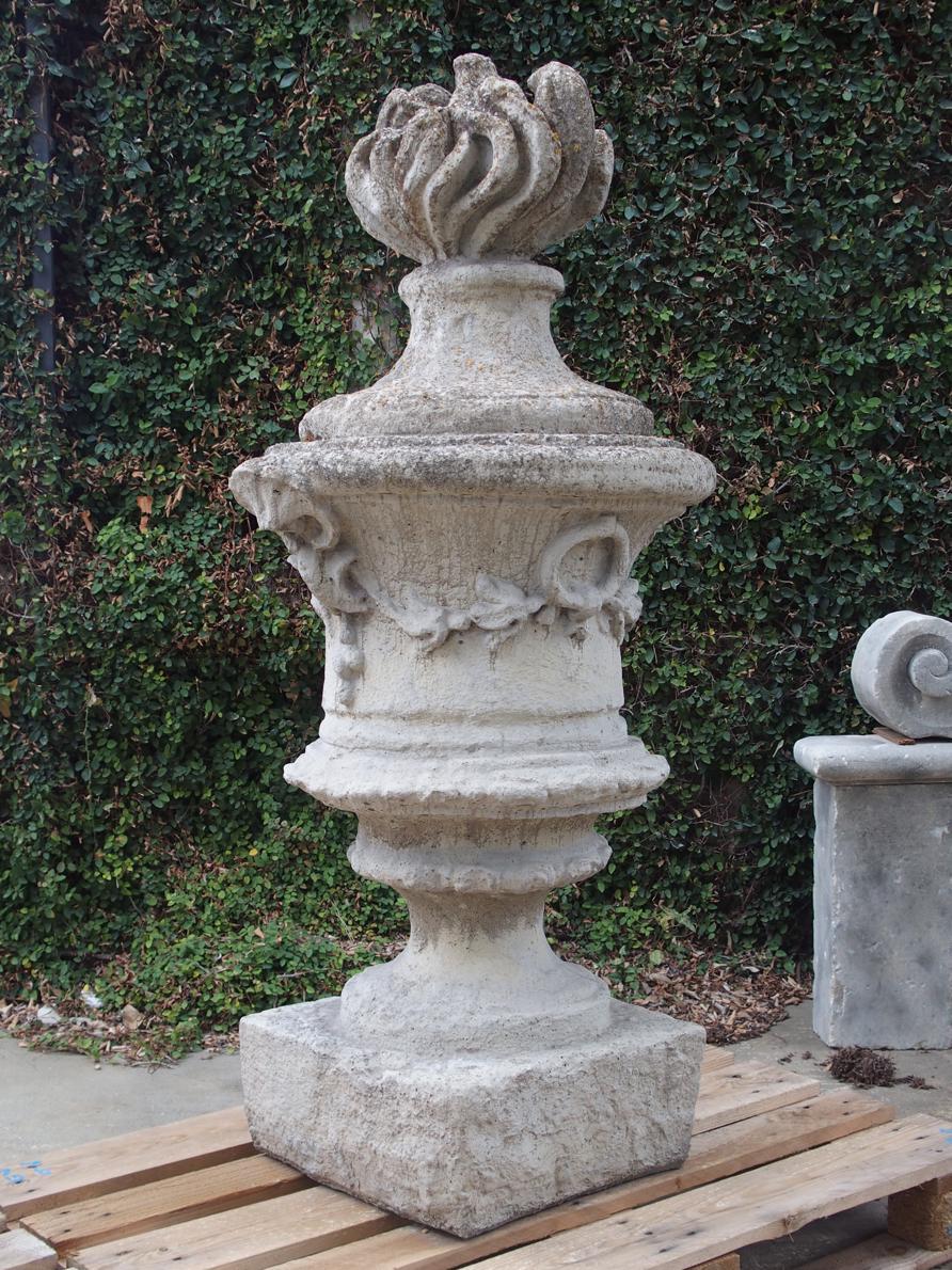 This pair of large cast stone garden finials are referred to as “Pot A Feu”. First used in France during the 16th century, they gained popularity throughout the 17th century during the Baroque period. Inspired by erupting fireworks, pots a feu were