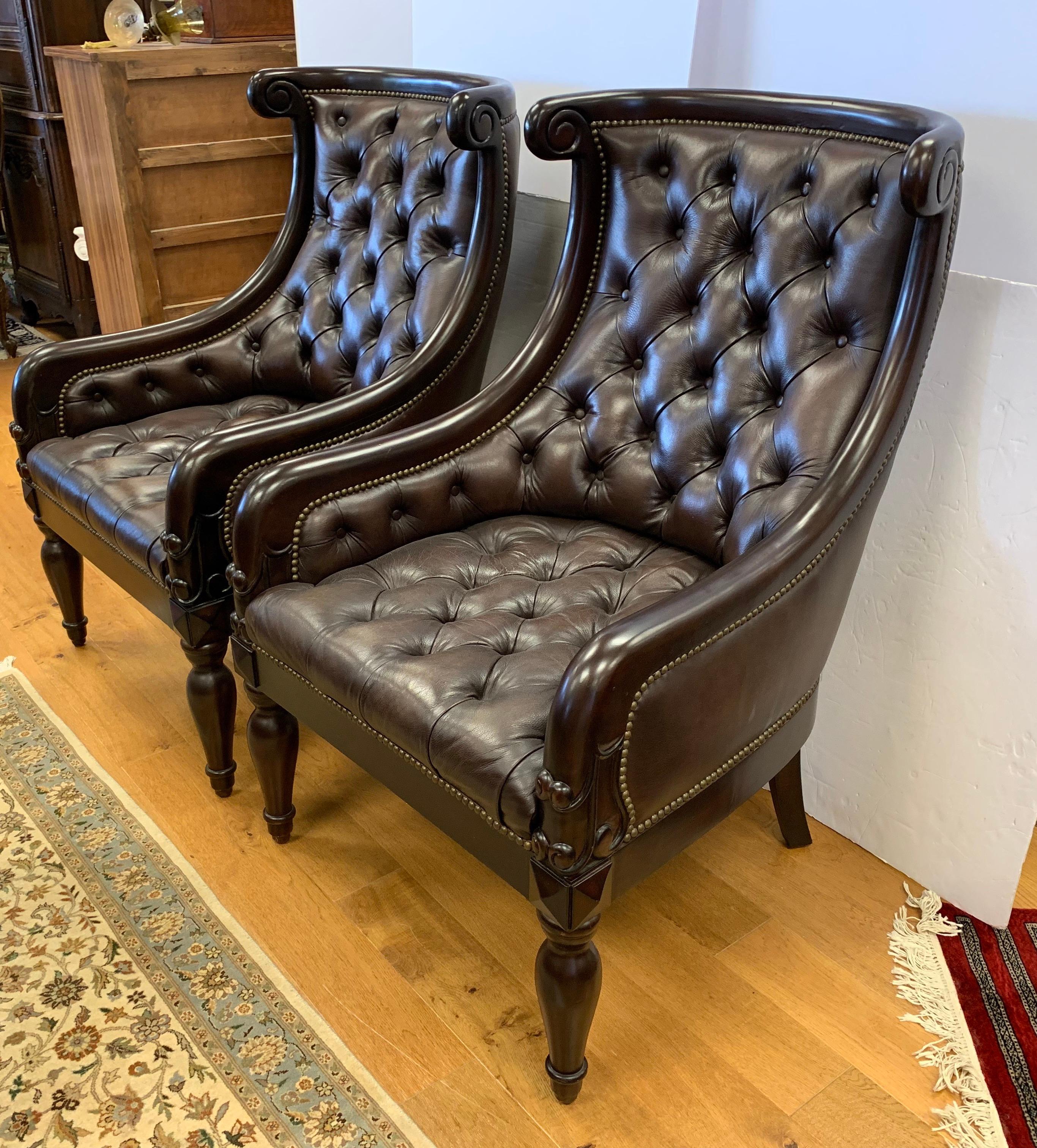 Stunning pair of matching dark brown leather tufted Chesterfield armchairs with mahogany wood.
These are big masculine chairs; please see dimensions below. They are spectacular.