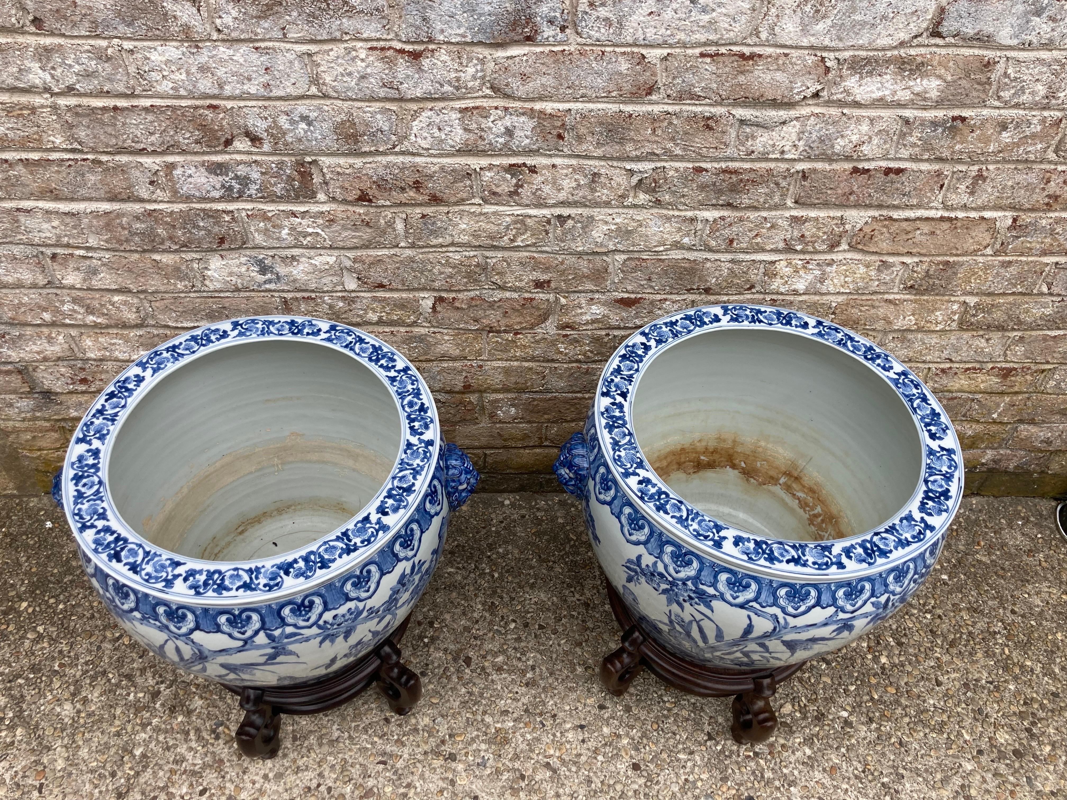 Large pair of Chinese blue and white planters on stand. 21