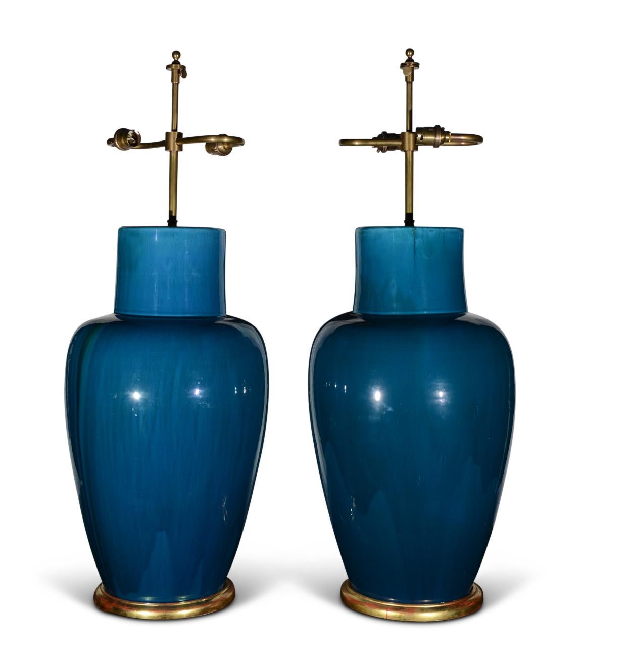 A superb pair of late 19th century, early 20th century large Chinese turquoise flambé glazed baluster vases, each with shouldered ovoid bodies with cylindrical necks, now mounted as table lamps with hand gilded turned bases.

Height of vases:  20