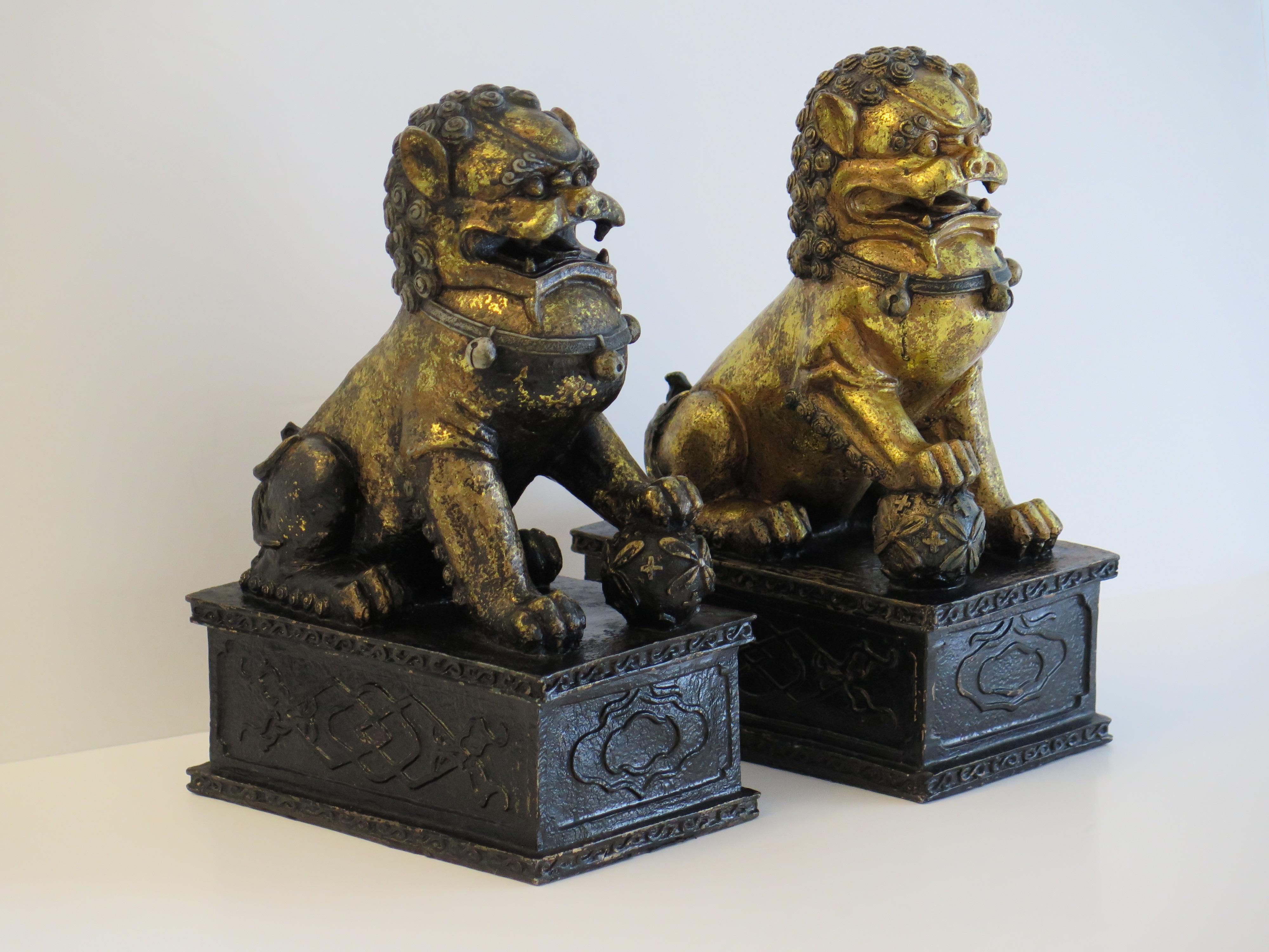 These are a very good Large pair of Chinese foo or lion dogs on plinth's, sometimes called temple lions made of metal and hand gilded with fine detail, all in the Ming style but dating to the 20th century, Circa 1920s period.

These are an unusually