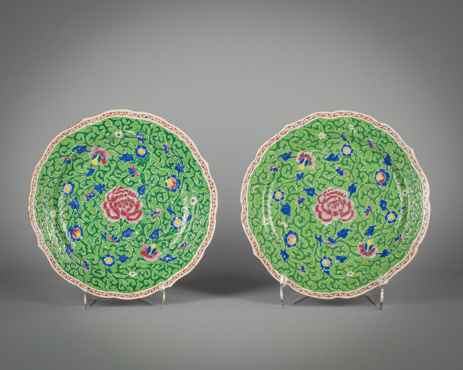 Finely enameled in shades of rose and cobalt with flowers with dark green tendrils, the border with iron red scroll pattern. 