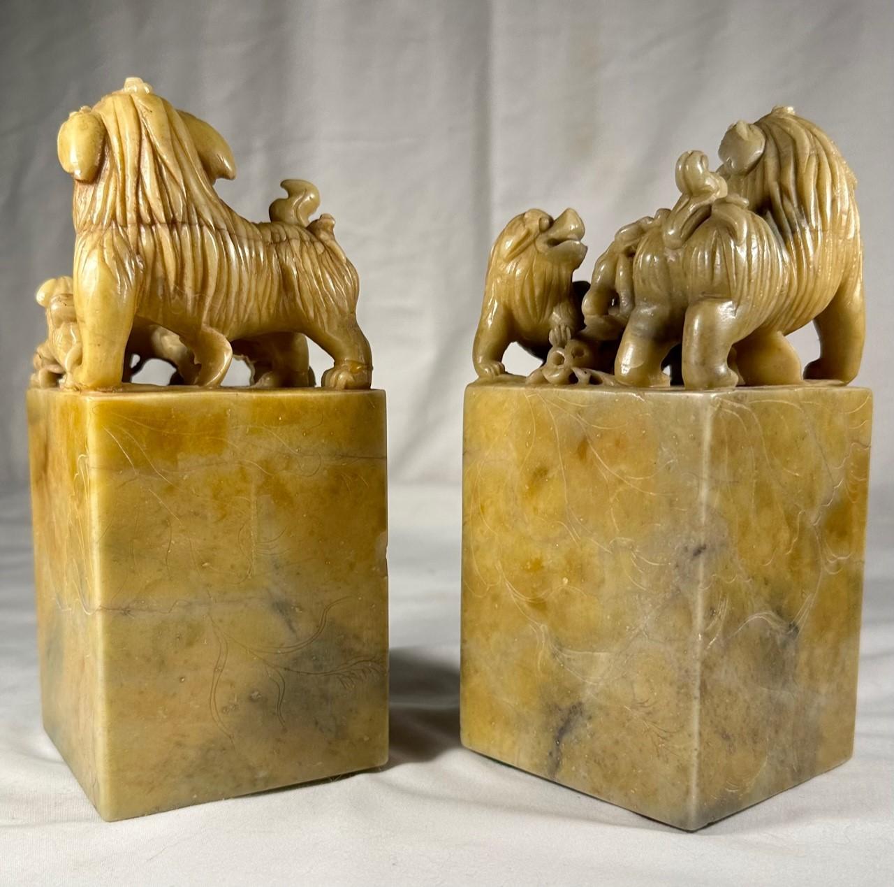 Pair of Large Chinese Qing Dynasty Carved Soapstone Seals.

Large and rare pair of hand carved soapstone Foo Dog seals. Beautiful sculptures of finely carved group of Foo Dogs topping a rectangular plinth with floral panels encised on the sides.