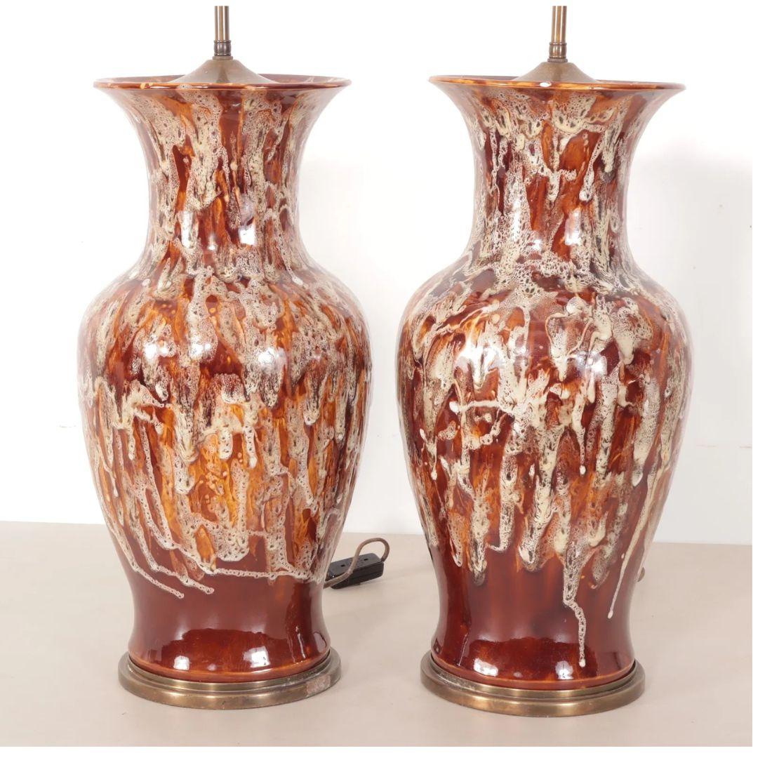 A striking pair of large earthenware table lamps, beautifully crafted in the style of renowned designer Christopher Spitzmiller. These substantial ceramic forms feature an elegant, high-gloss drip glaze in rich chocolate brown and creamy ivory